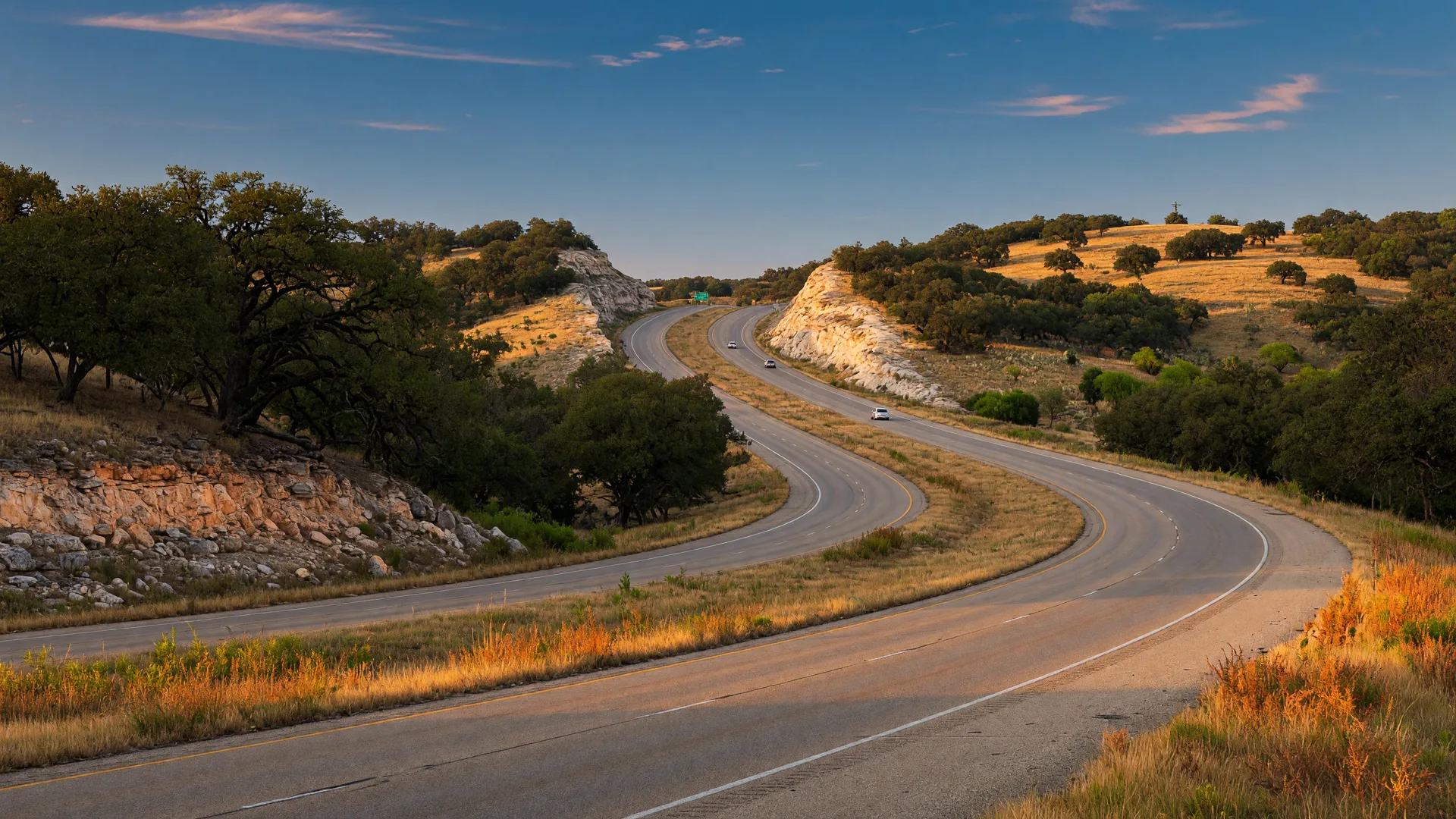 An open Texas Hill Country highway at golden hour