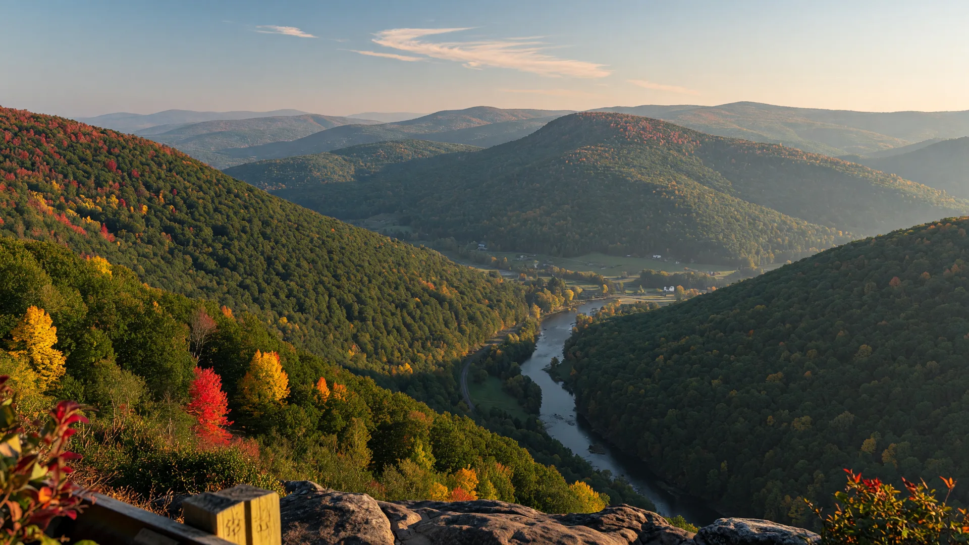 Eastern Pennsylvania forested hills in early October with patches of gold, orange, and red foliage against the Blue Mountain ridge