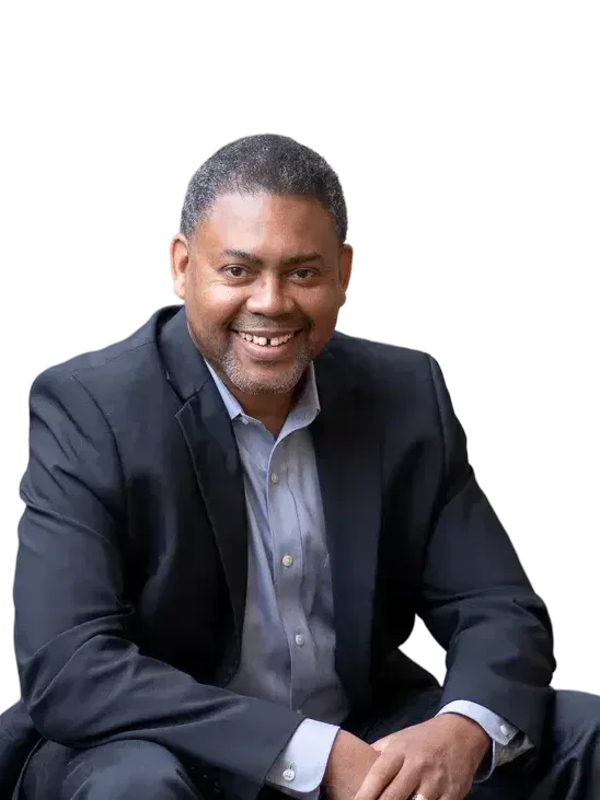 Garland Best, smiling in a dark suit