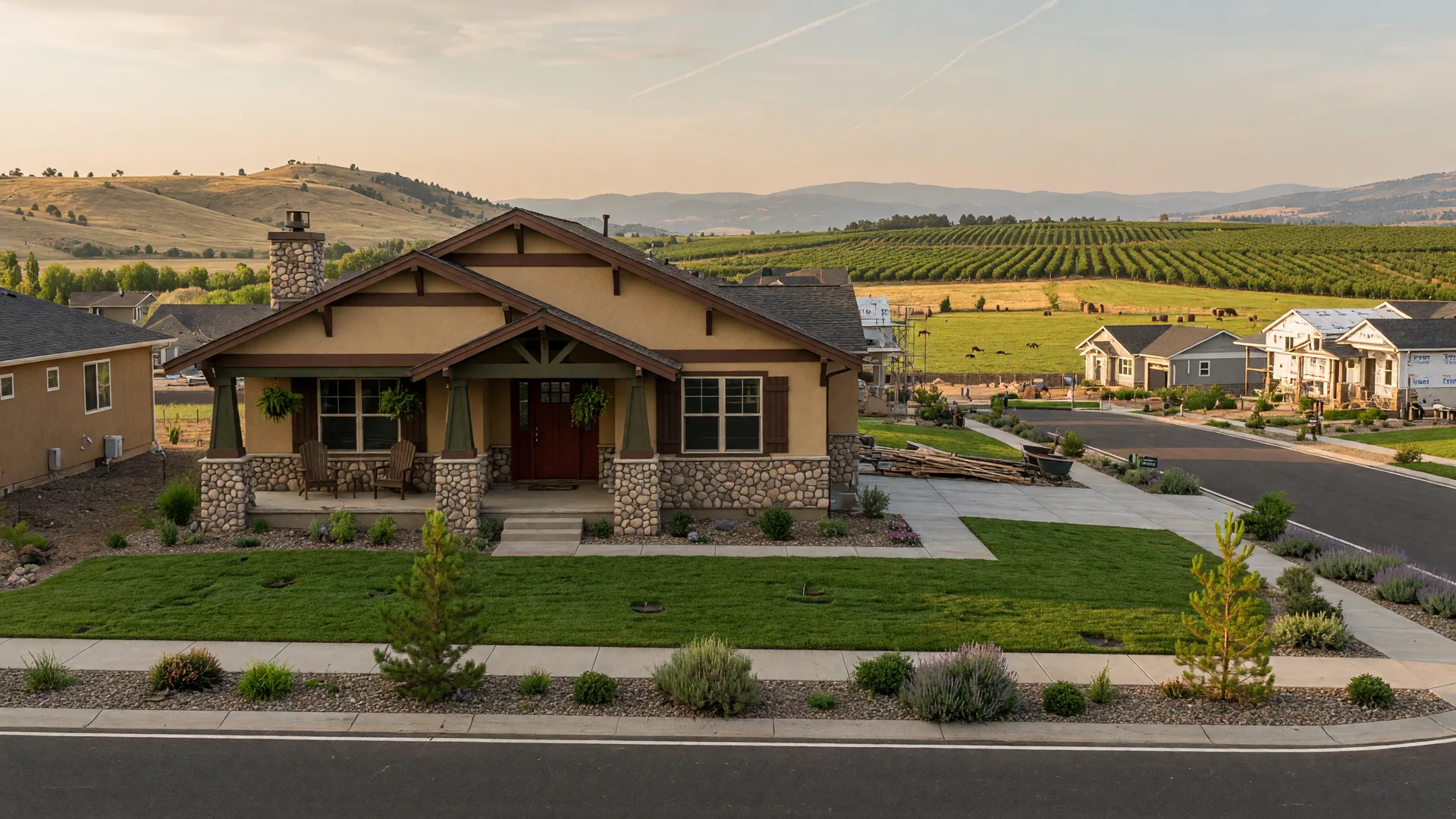 New craftsman-style home with covered front porch in a Central Point neighborhood, Rogue Valley hills in the distance