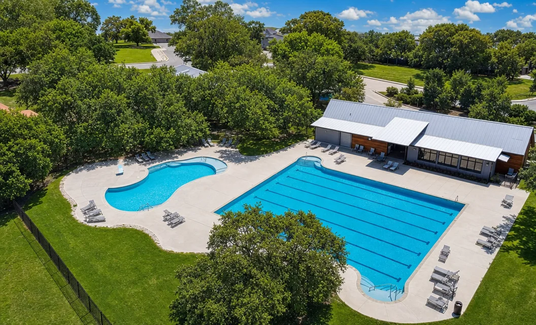 Aerial view of the Balcones Creek pool complex with the Junior Olympic pool, children's pool, and clubhouse.