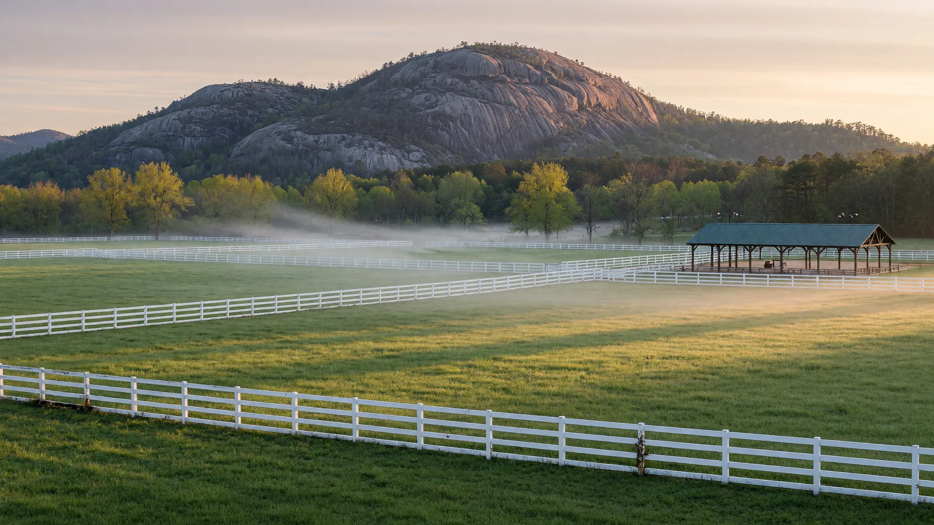 Equestrian meadow and a granite ridge in Rockdale County, Georgia at dawn