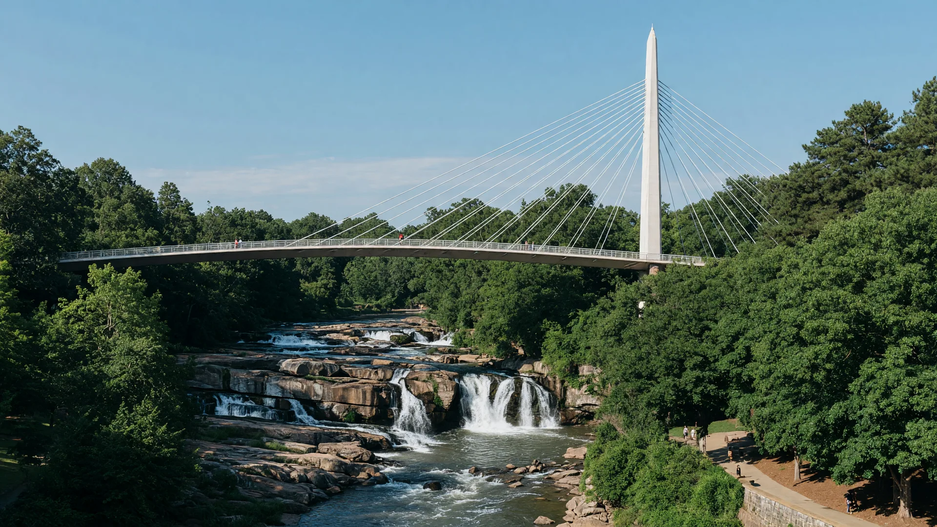 The Liberty Bridge curving over the falls of the Reedy River in Falls Park, downtown Greenville