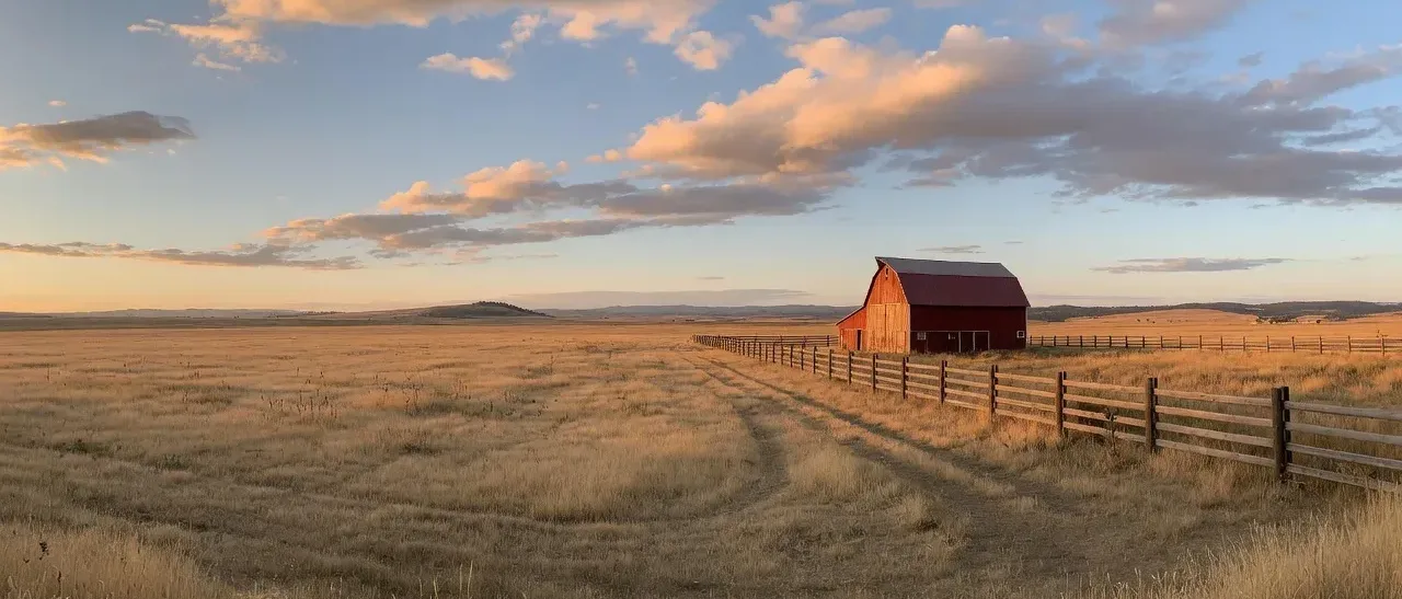 Oregon farmland with red barn at golden hour in Lane County