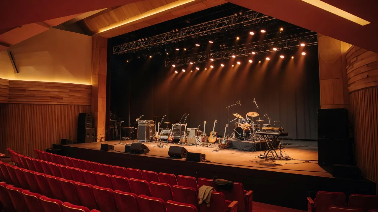 The Choctaw Grand Theater stage with warm amber lighting and red velvet theater seats