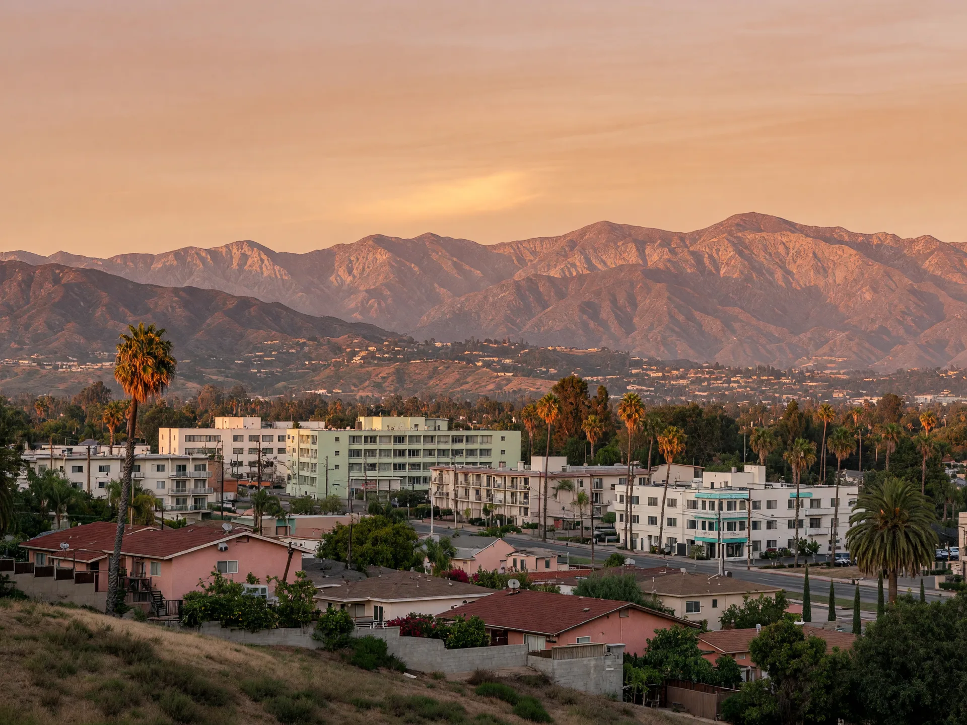 A Southern California city and the San Gabriel Mountains at golden hour, the bigger region that Pasadena and its neighbors share