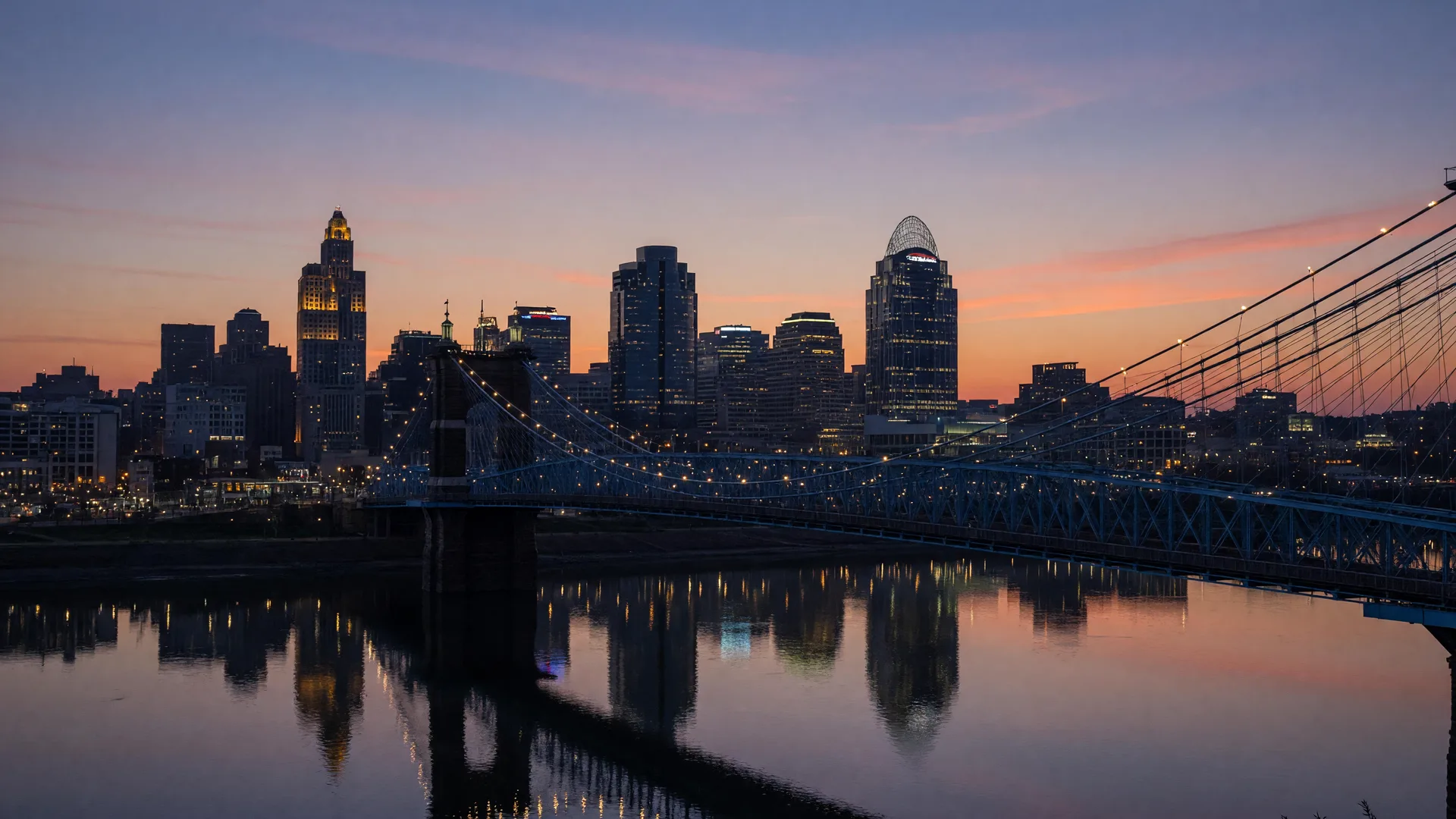 The Cincinnati skyline across the Ohio River at dusk, seen from the Kentucky side