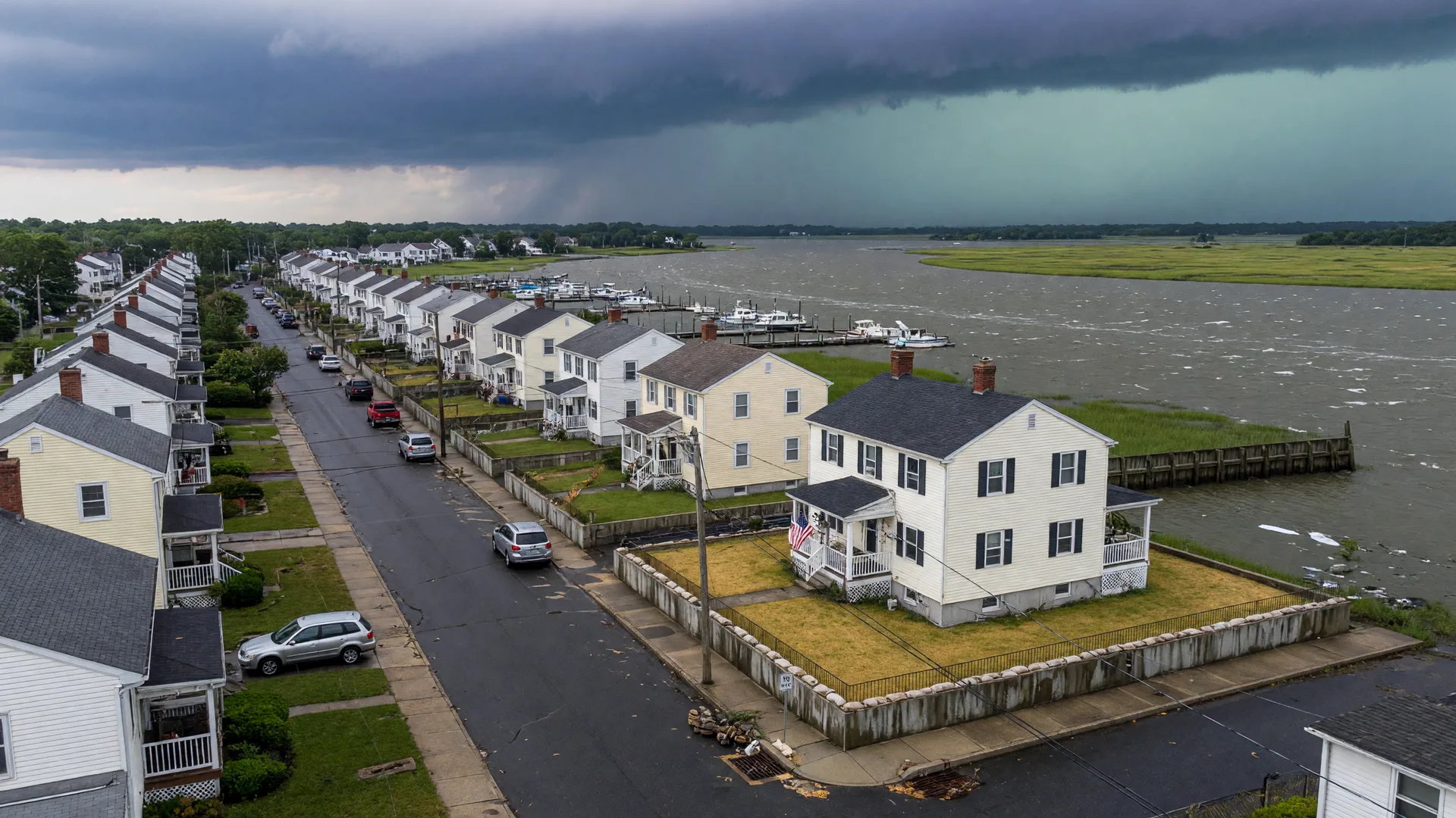 Storm clouds gathering over a South Jersey residential street near the water with a home on a raised foundation