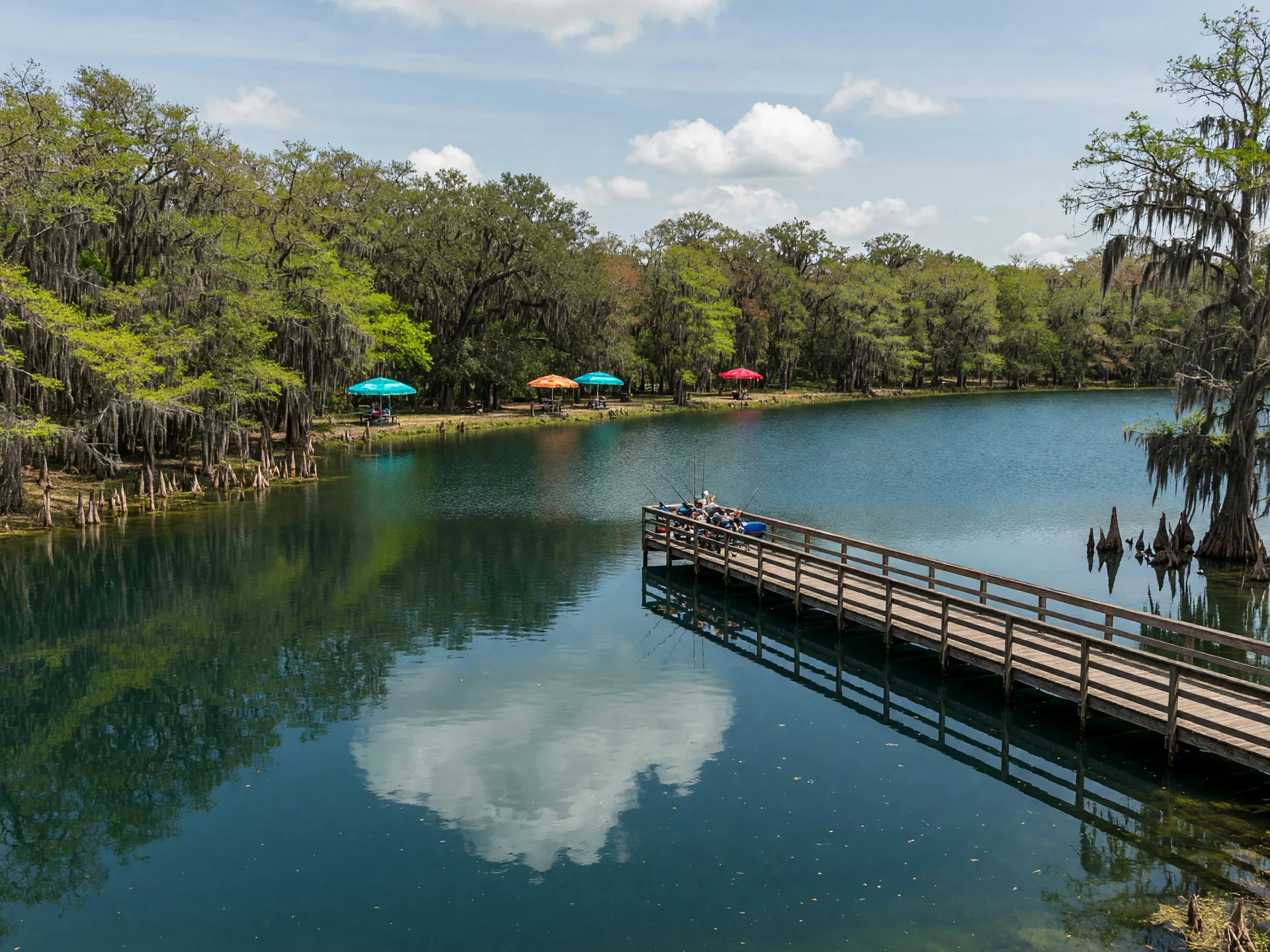 Saddle Creek Park near Polk City, Florida with a fishing pier over a broad water-filled former phosphate pit lake