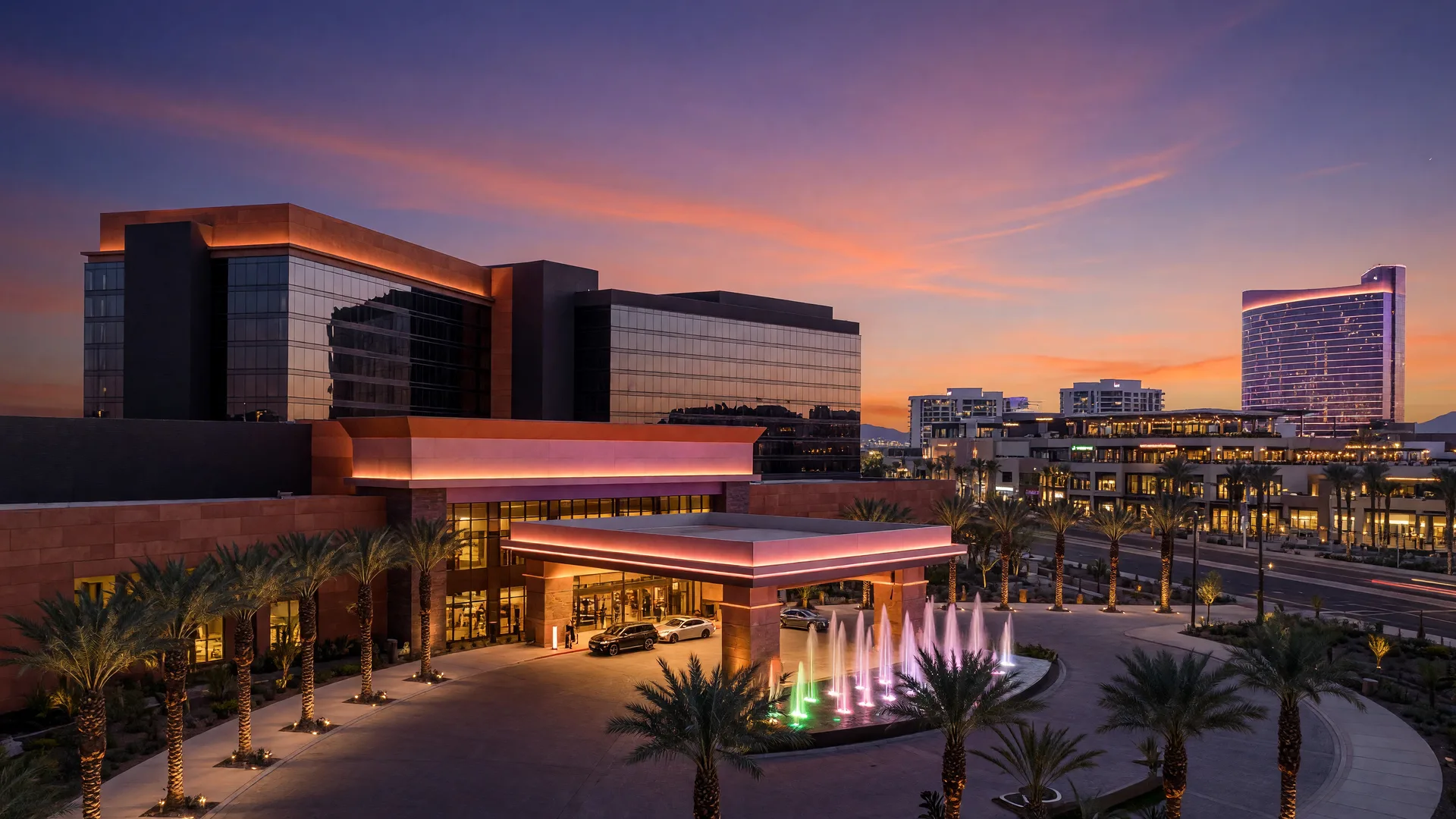 Durango Casino Resort at dusk with dramatic sunset sky and palm trees in Southwest Las Vegas