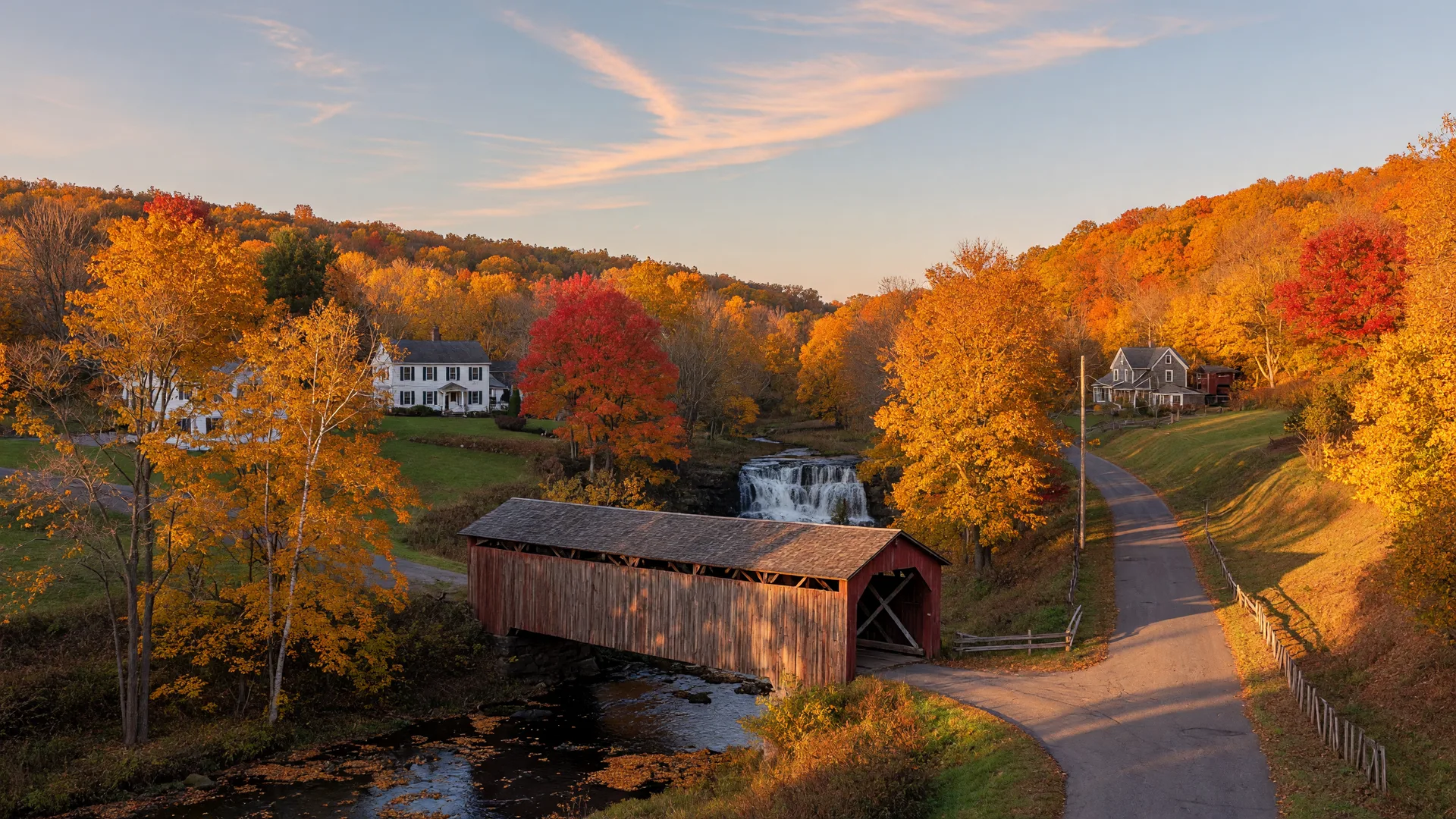 Autumn landscape in rural Oxford, Connecticut with a covered bridge and golden fall foliage