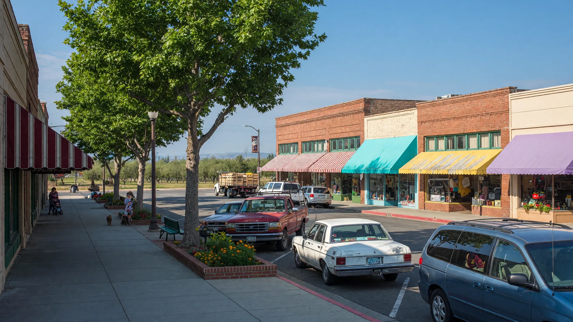Downtown Livingston, California with local storefronts, shade trees, and small-town main street character