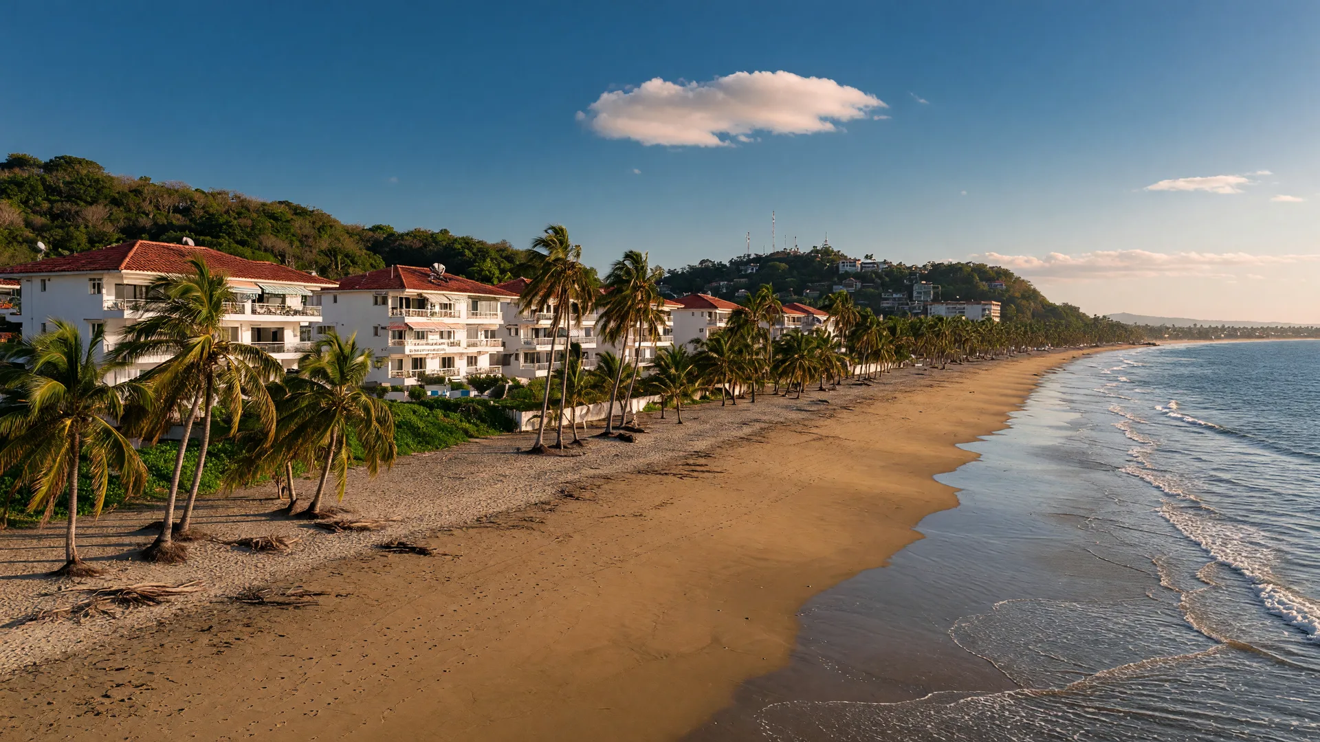 A wide stretch of Pacific beach in Panama with leaning palm trees and beachfront condos near Coronado