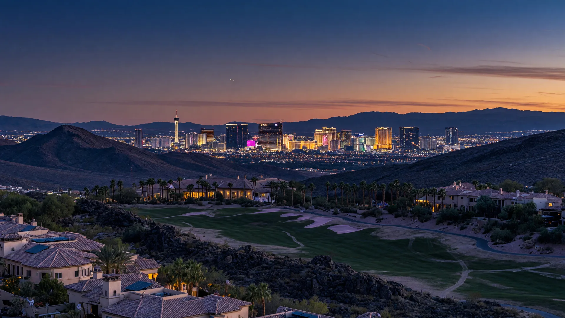 A dusk view from an elevated Southern Highlands estate position across the desert valley toward the glowing Las Vegas Strip skyline