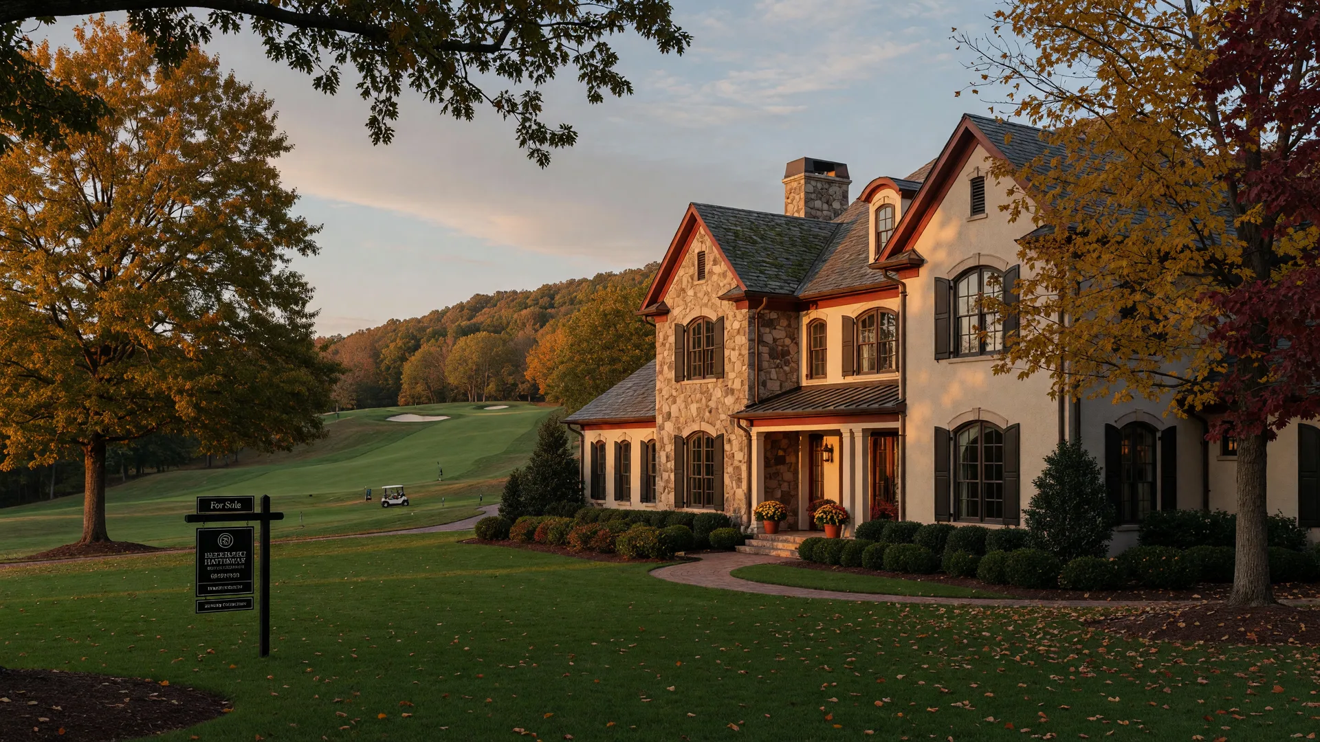Luxury stone and stucco estate home in an upscale Georgia golf course community in early October with a For Sale sign and turning autumn leaves