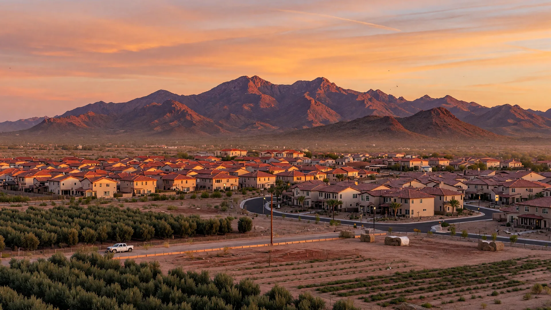Golden hour view of Queen Creek, Arizona, with new master-planned neighborhoods and the San Tan Mountains on the horizon