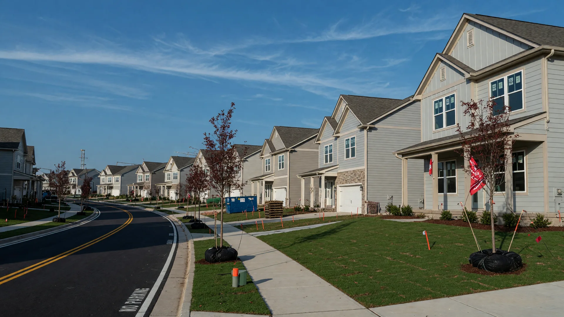 Brand-new single-family homes in a South Metro Atlanta community with fresh lawns on a bright morning