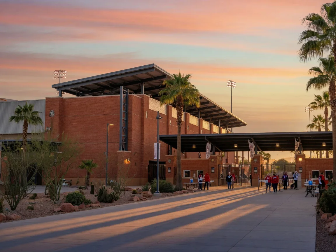 Peoria Sports Complex stadium entrance with palm trees and desert landscaping at dusk
