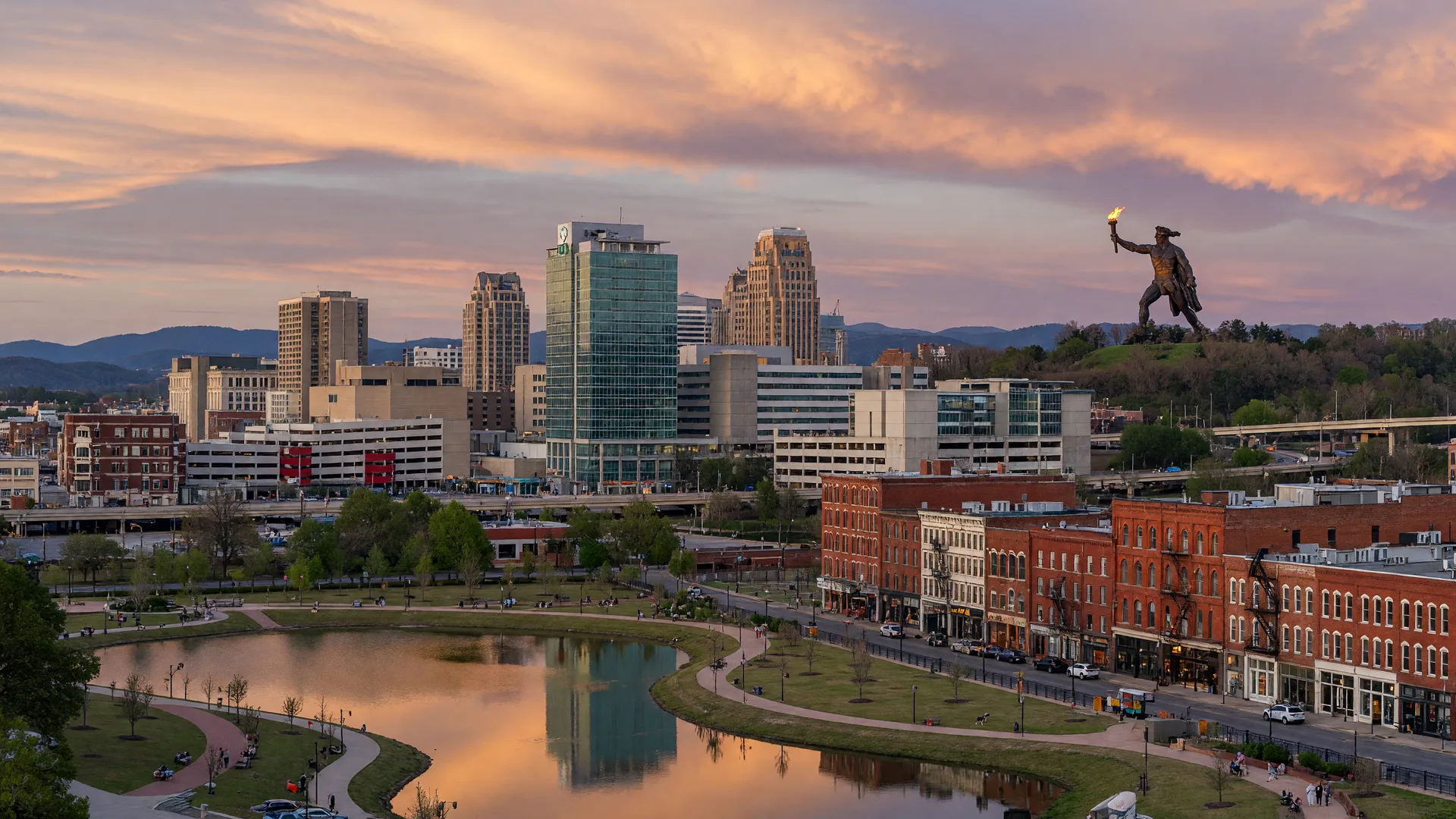 Birmingham's downtown skyline with the iconic Vulcan statue, UAB campus, and Railroad Park at late afternoon
