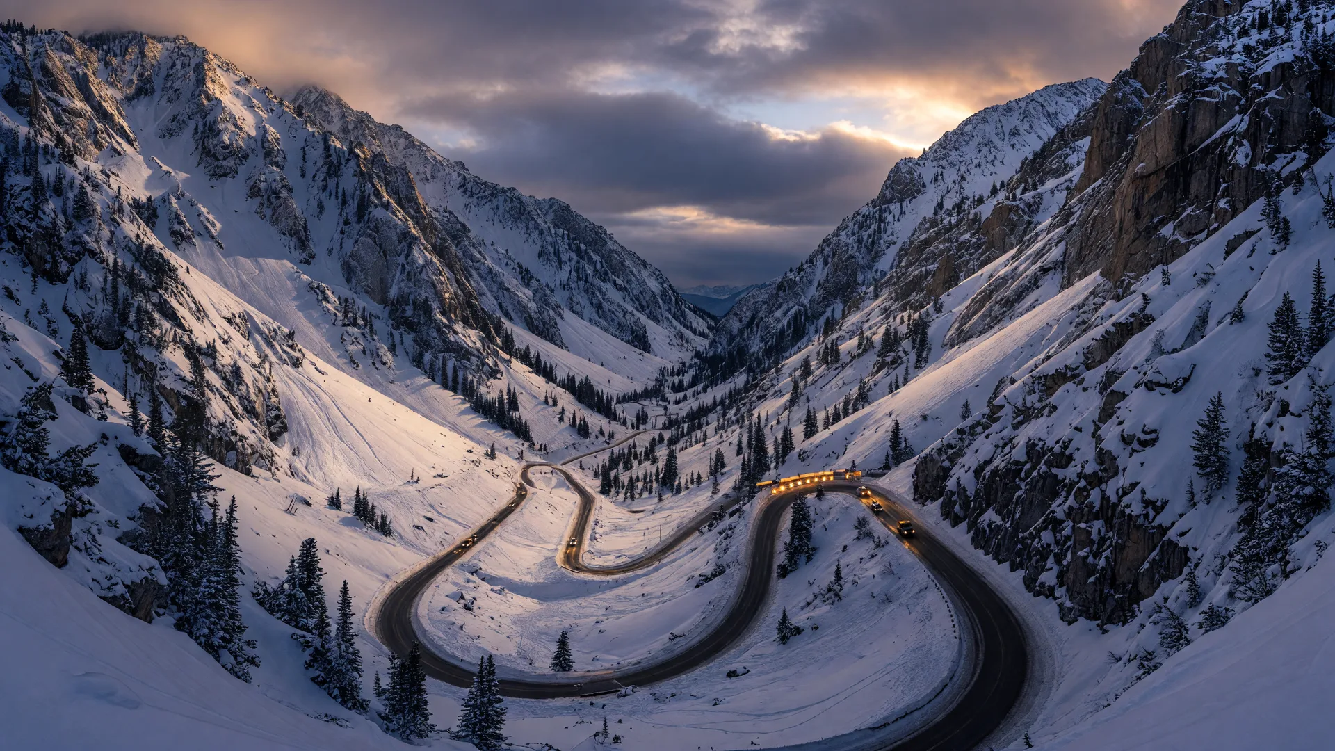 Little Cottonwood Canyon in deep winter with the winding canyon road climbing between avalanche-scarred slopes toward Alta and Snowbird