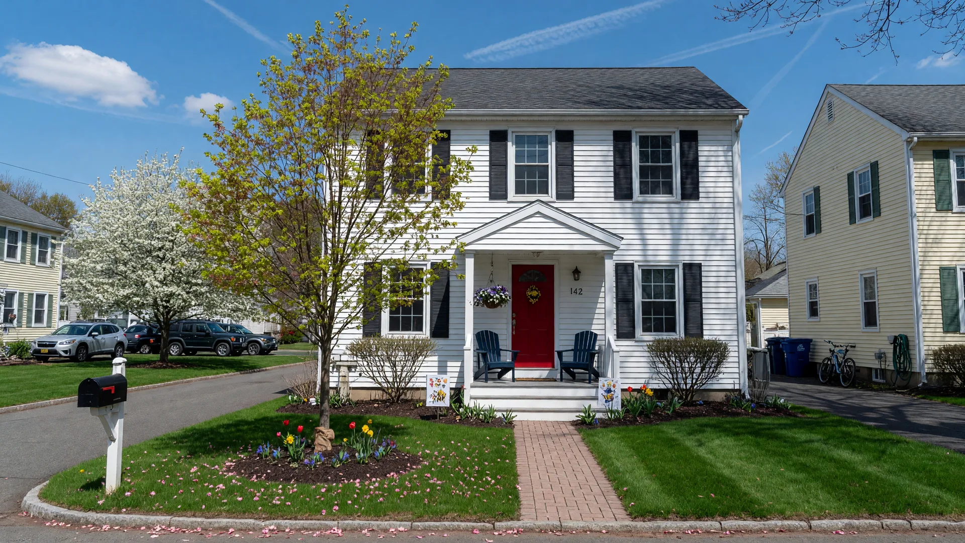 A modest starter colonial home in a Connecticut neighborhood on a sunny day