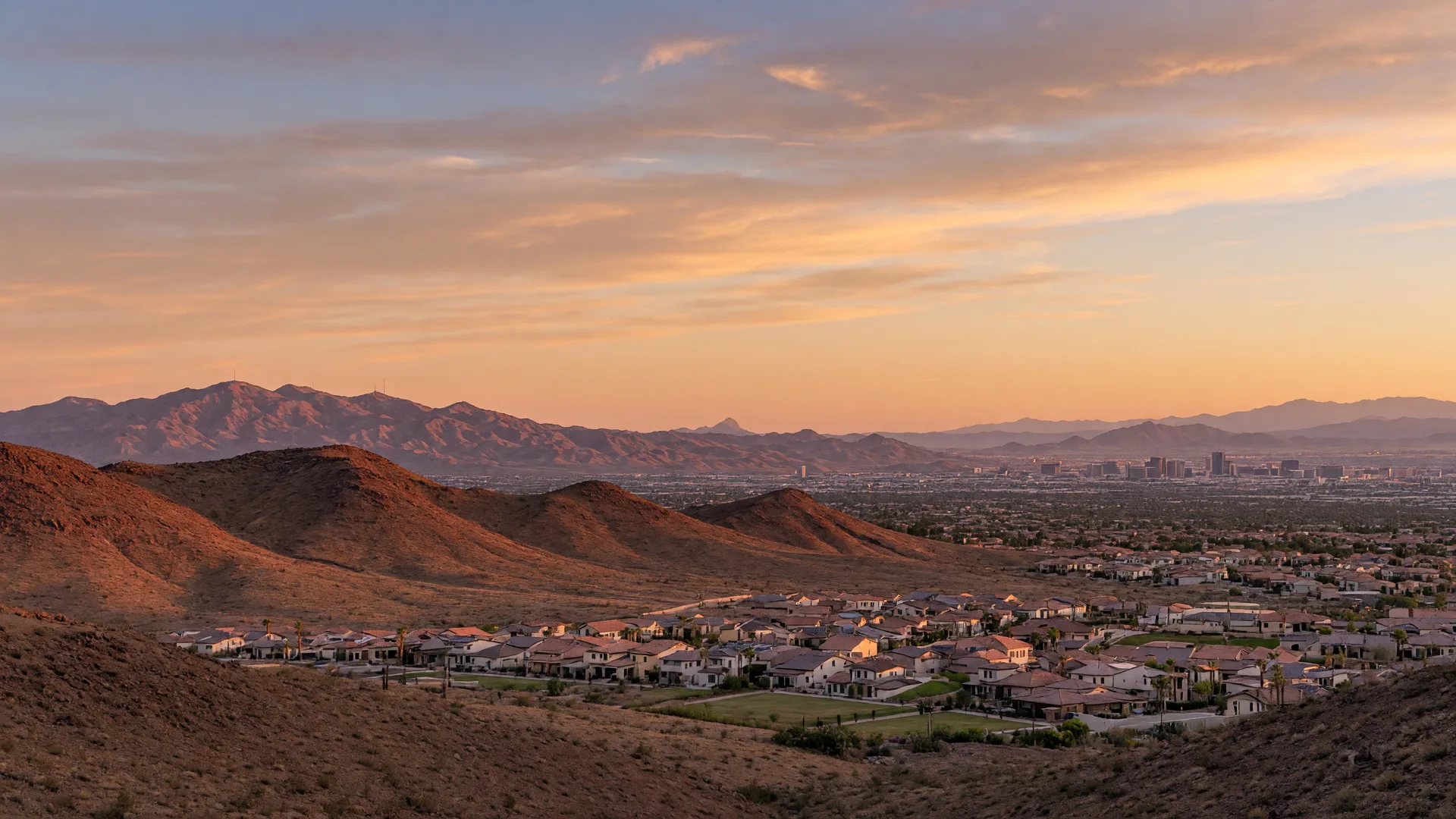 Golden-hour view across desert ridges toward a Henderson master-planned community