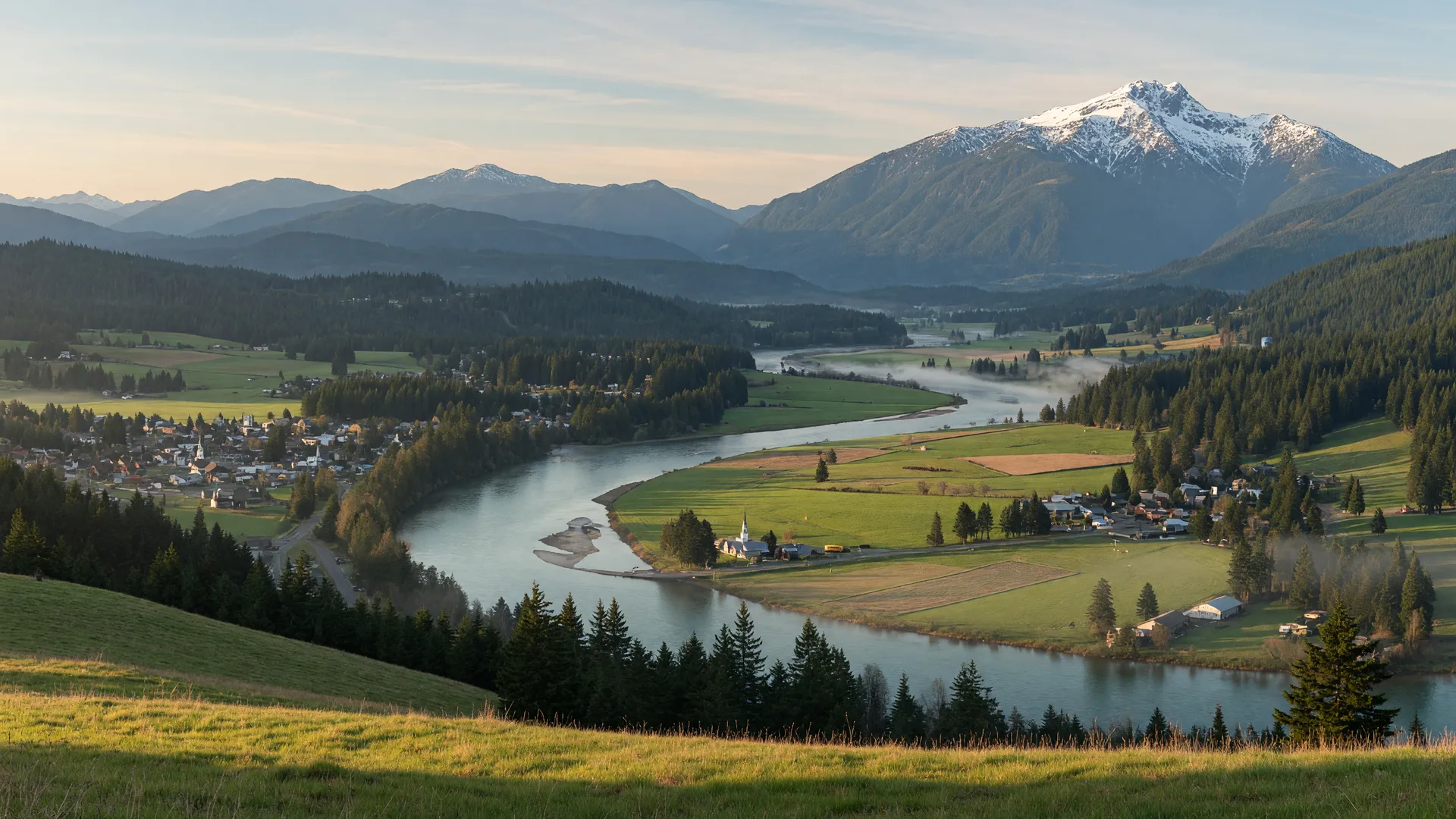 A wide view of the Snoqualmie Valley with the river curving through farmland and forest