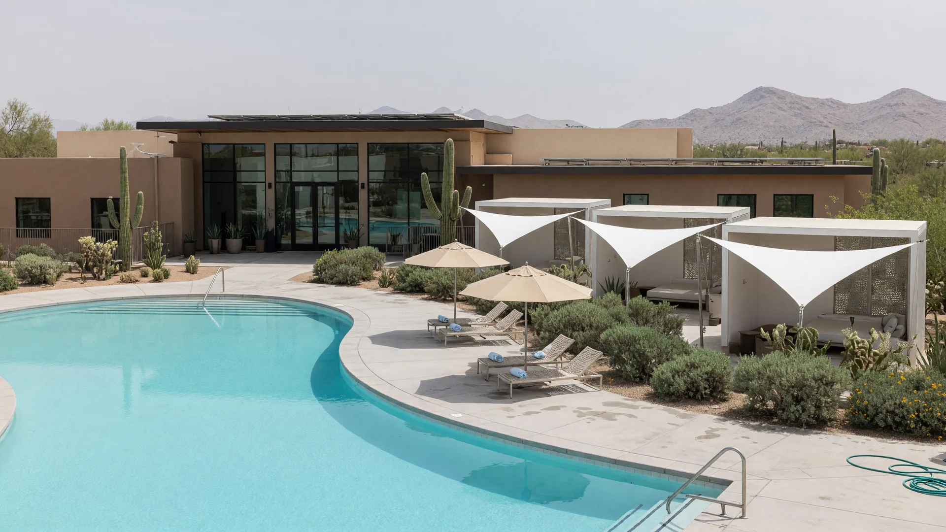 Palm-lined pool and clubhouse at an active-adult resort community in Surprise