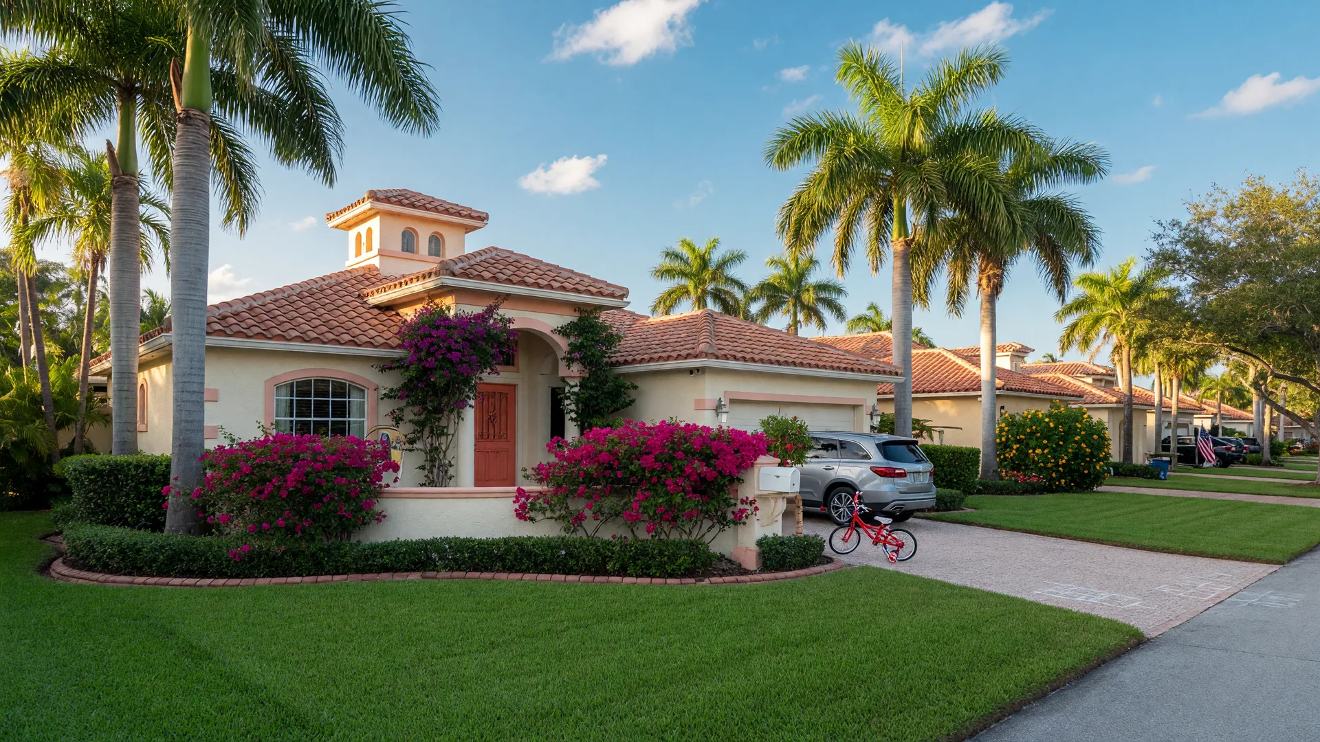Mediterranean-style home with lush tropical landscaping on a sunny Boca Raton residential street