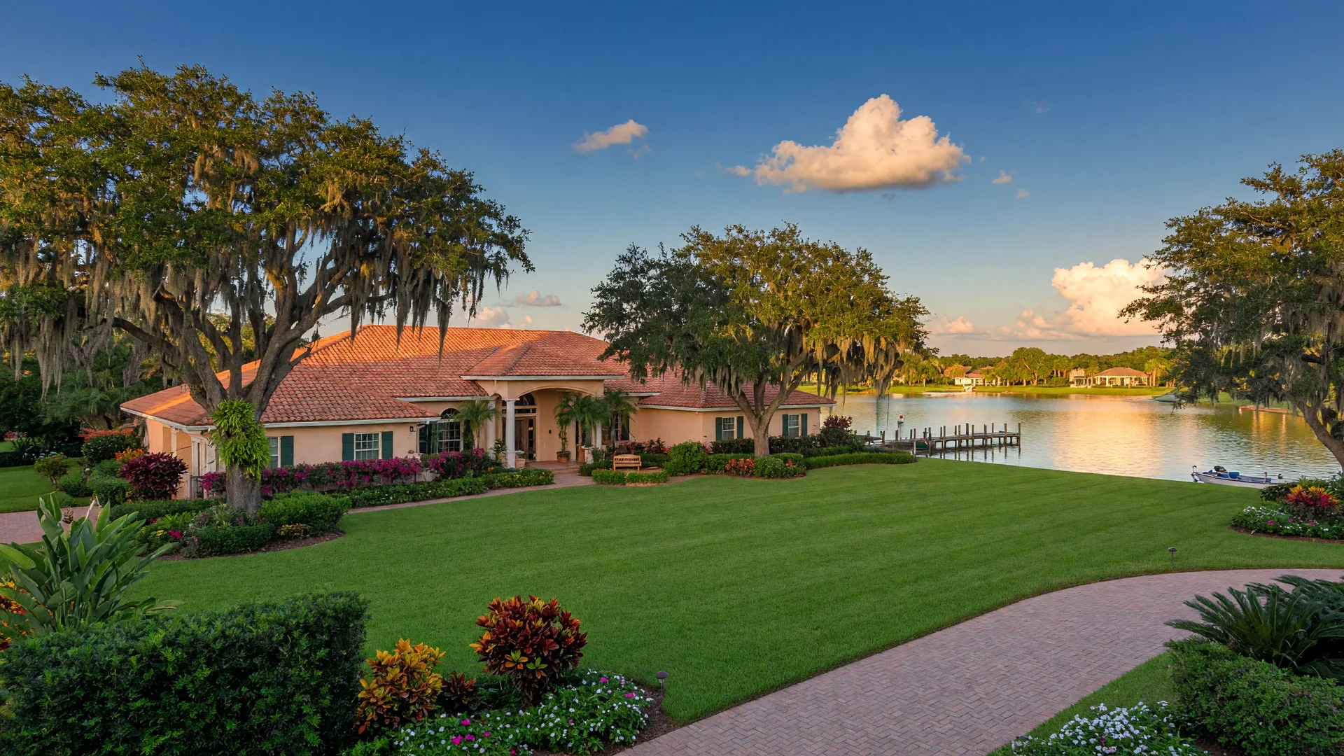 Estate home in Odessa Florida with Spanish-moss-draped oaks and manicured lakefront lawn