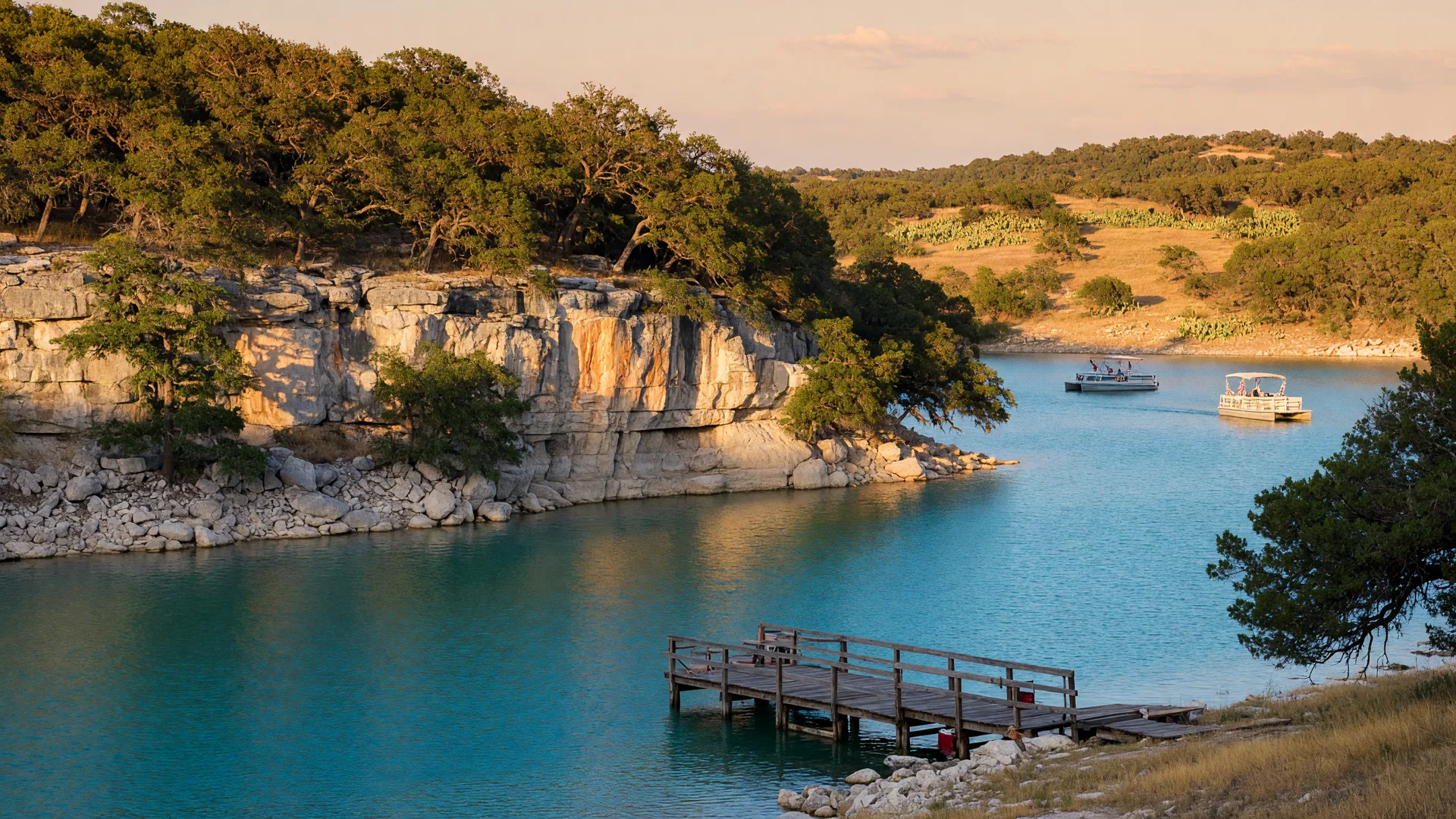 Canyon Lake at golden hour with turquoise water reflecting a warm amber sunset, limestone cliffs draped in live oaks, and a wooden dock reaching into the lake