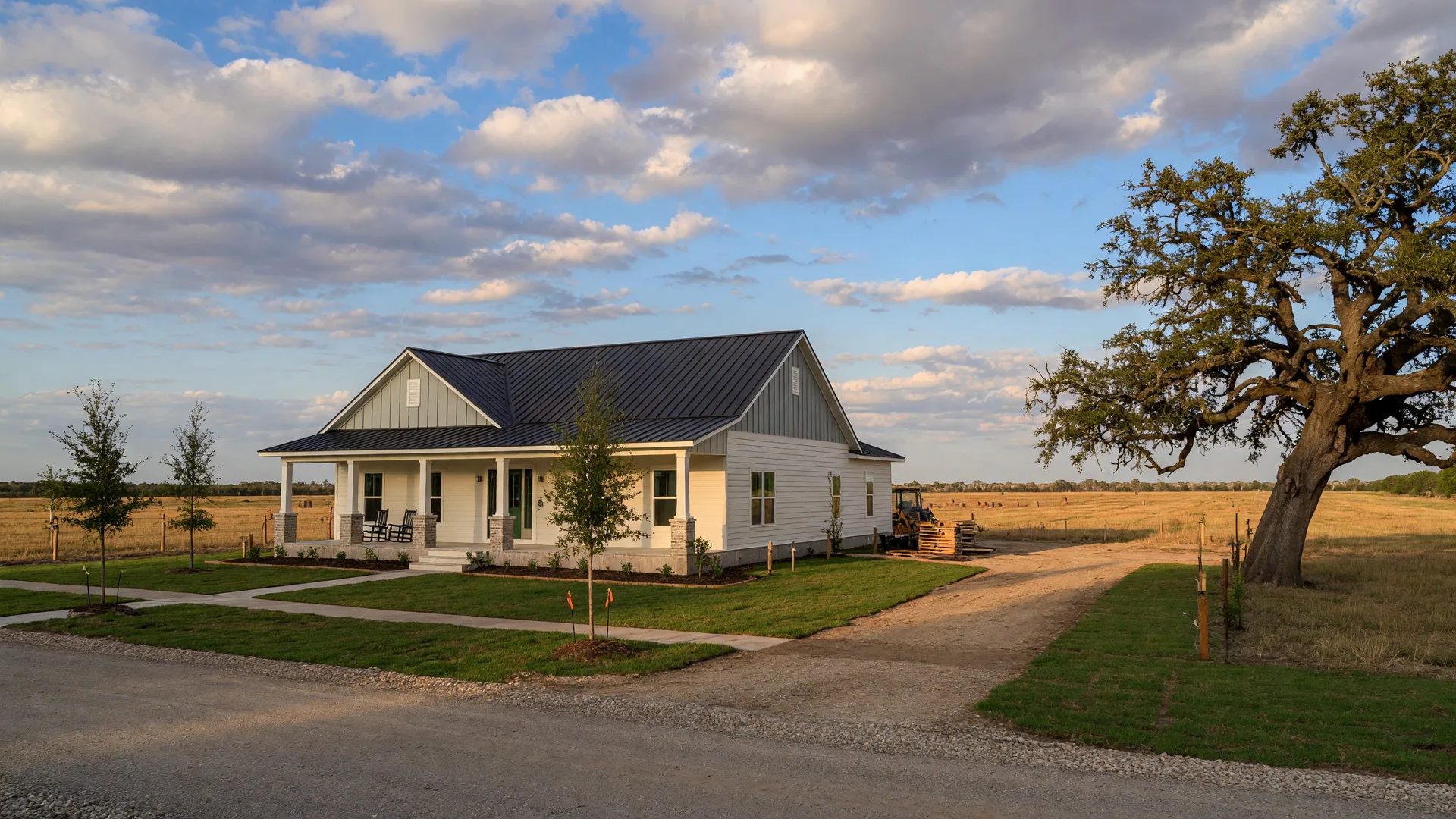 A new farmhouse-style home on a former farm lot near La Vernia, Texas with an old live oak at the property edge, in the home inspection service area of Rodeo Home Inspections