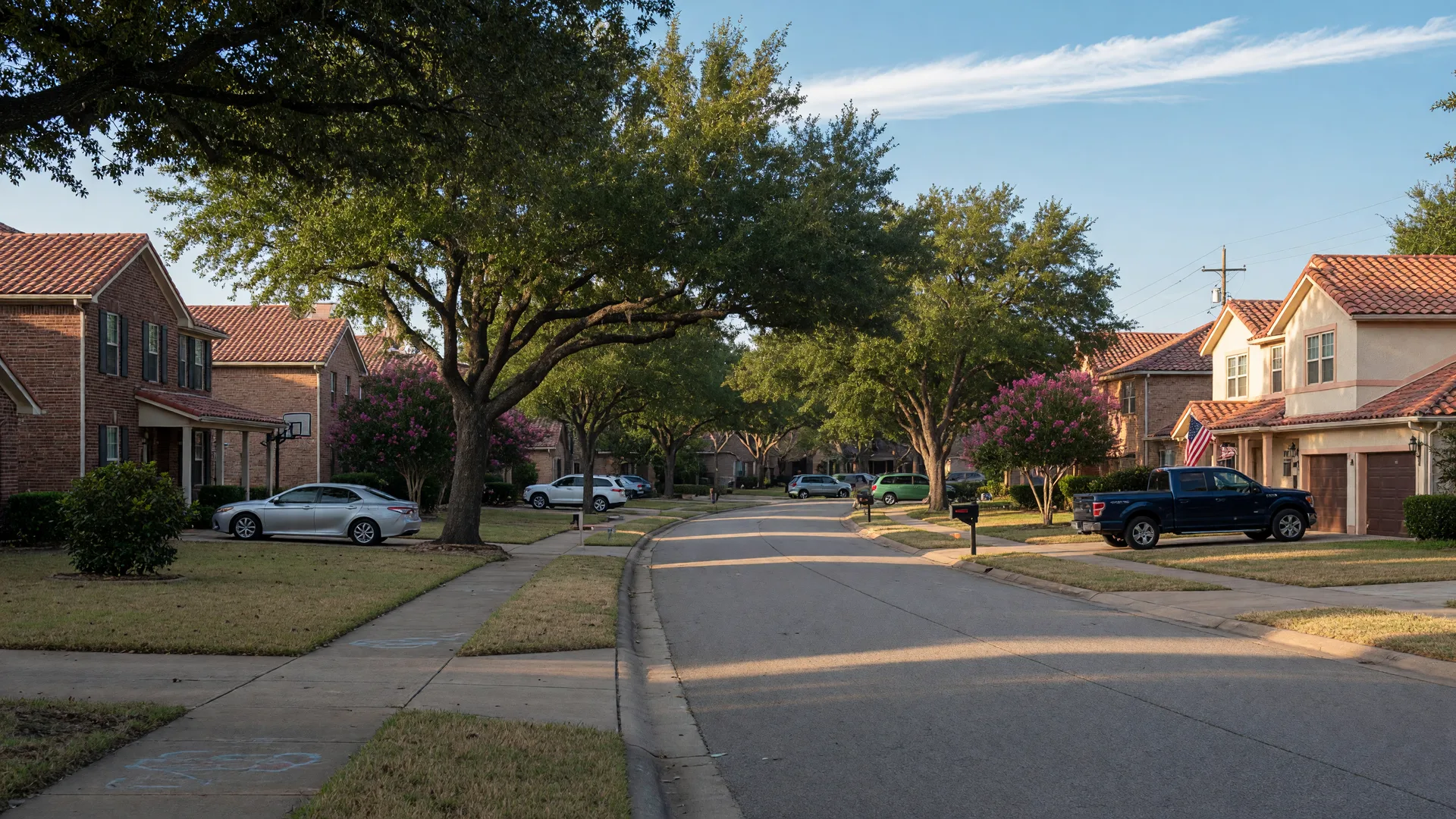 A leafy suburban street in Katy, Texas on a clear late-summer morning