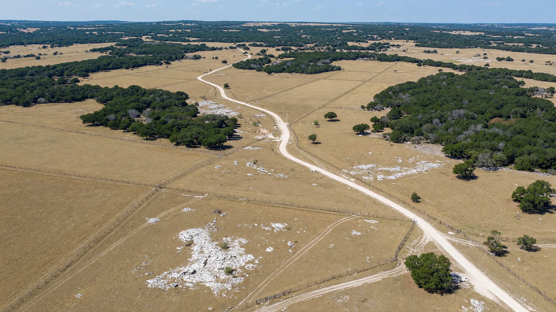Aerial view of Hill Country ranch parcels divided by fence lines showing boundary lines on the ground