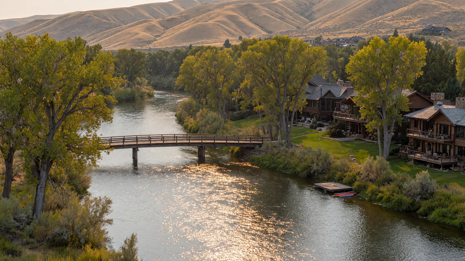 The Boise River near Eagle, Idaho with cottonwood trees, a footbridge, and foothills in the background