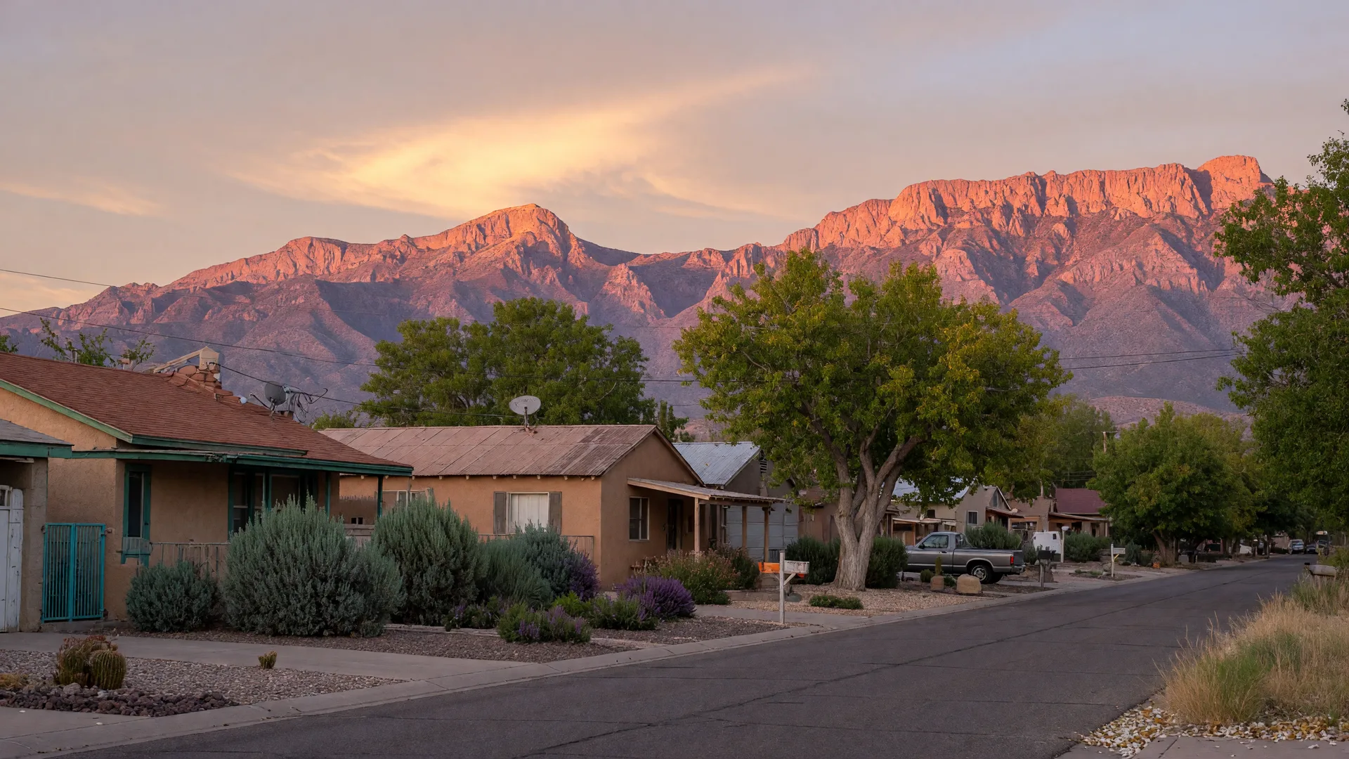 Albuquerque neighborhood homes with the Sandia Mountains glowing at golden hour