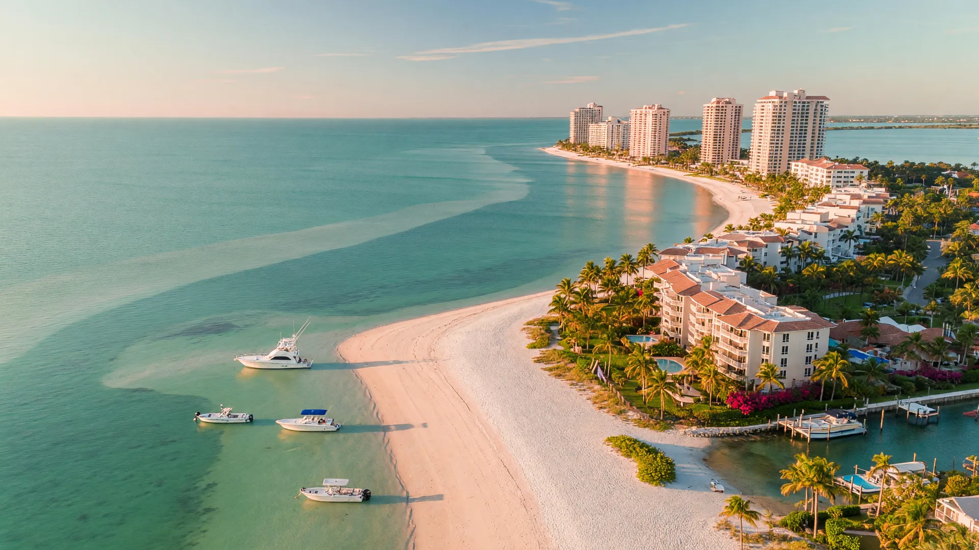 Aerial view of Marco Island, Florida with turquoise Gulf water, white sand beaches, and palm-lined waterfront homes