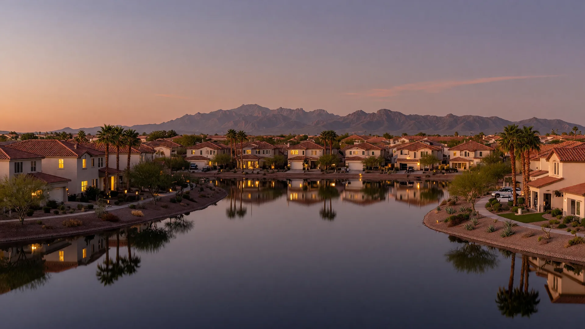 Modern master-planned community lake in Mesa reflecting new homes at dusk