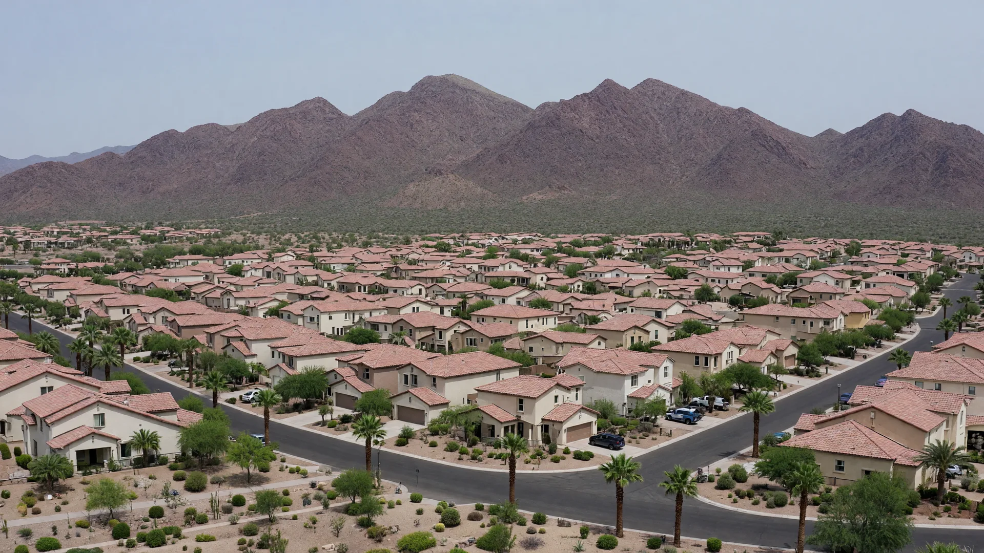 Golden hour view of Queen Creek, Arizona, with new master-planned neighborhoods and the San Tan Mountains on the horizon