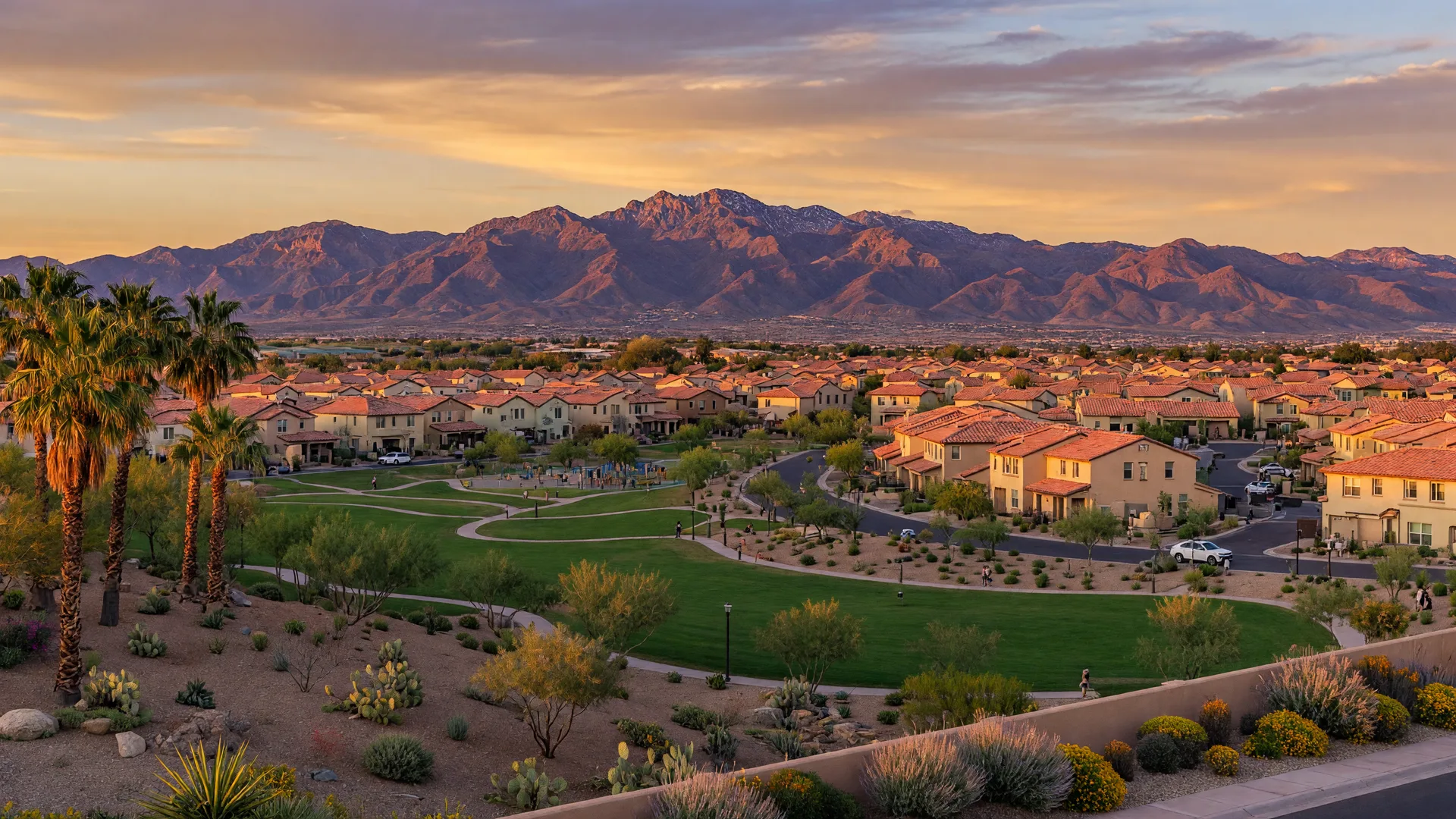 Scenic golden-hour view of Southwest Las Vegas master-planned communities with red-tile roofs, parks, and the Spring Mountains in the distance
