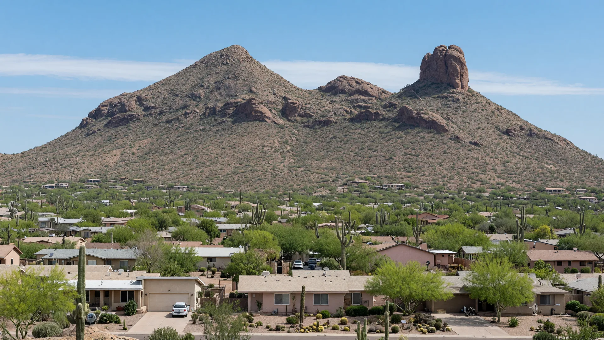 Camelback Mountain glowing at golden hour above saguaro-covered desert foothills in Phoenix