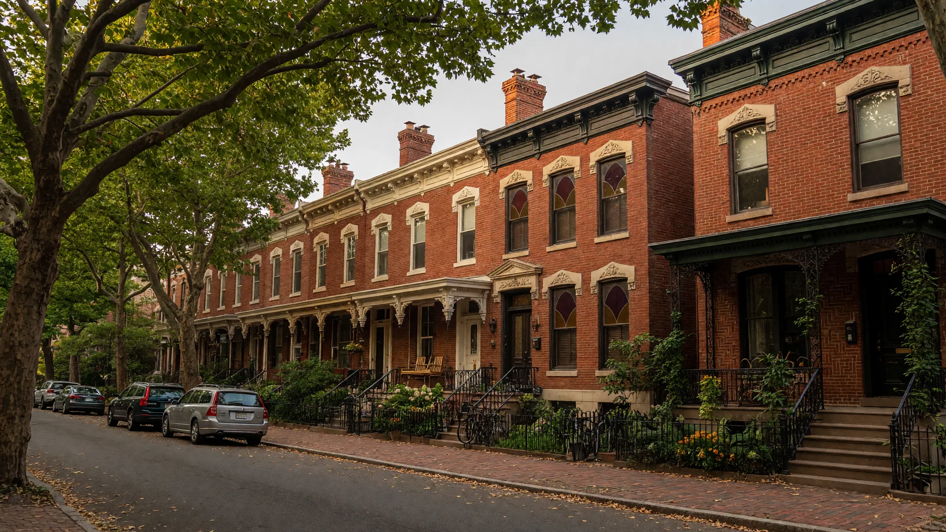 Tree-lined street with historic Victorian homes in Powelton Village, Philadelphia on a late summer afternoon