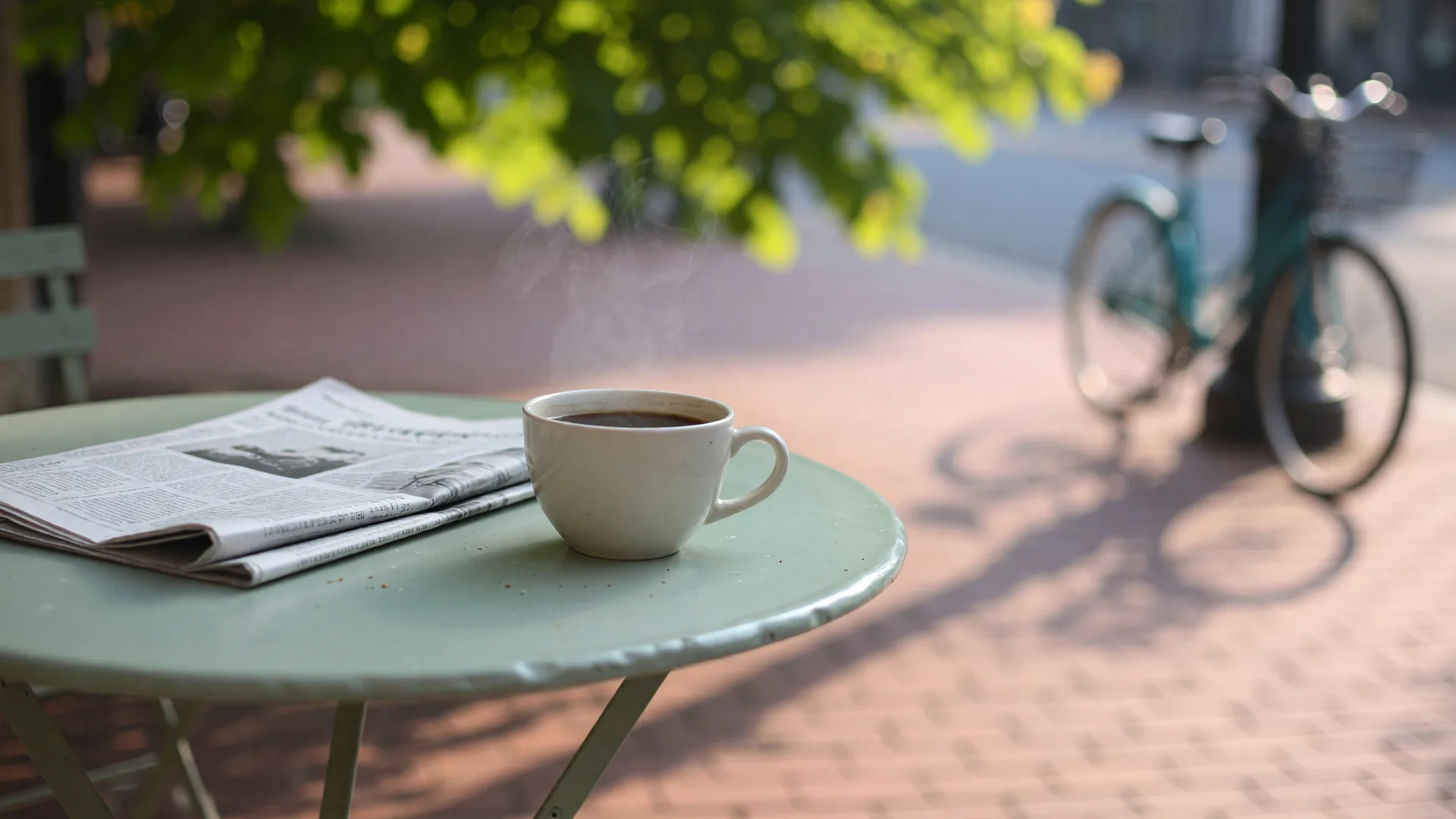 Morning light across a café table beside a quiet sidewalk