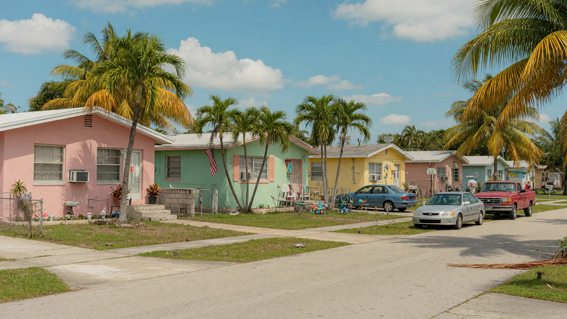 Quiet residential street in an affordable South Florida neighborhood near Delray Beach with palm trees and pastel homes