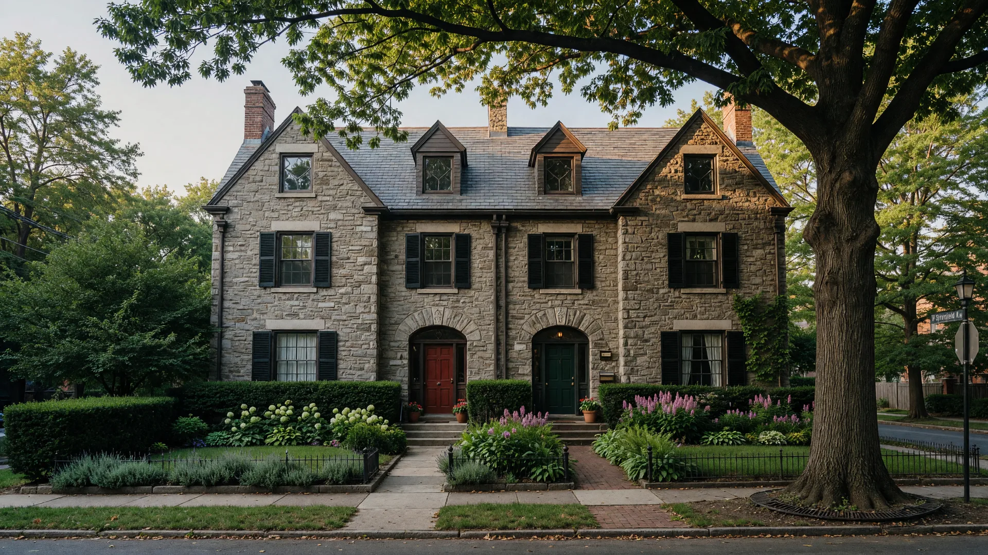 Historic stone twin homes in Chestnut Hill Philadelphia with pitched roofs and gardens