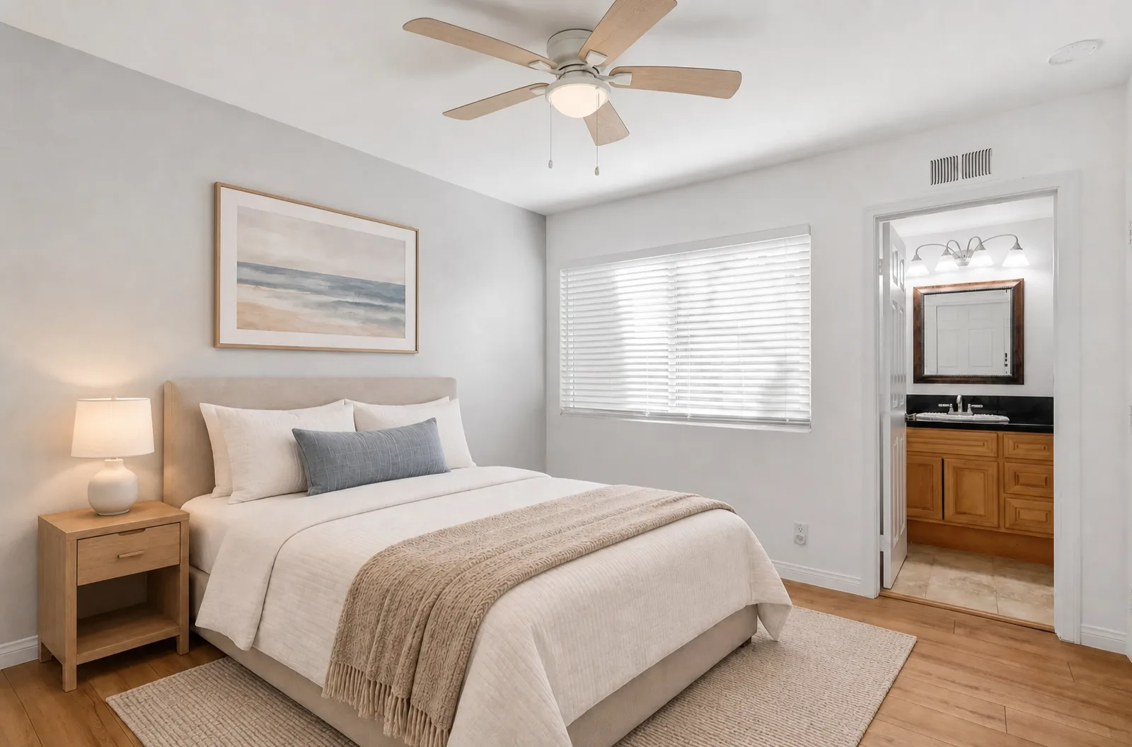 Virtually staged primary bedroom at 8 Silverwood with a bed, bedding, and a rug, the ensuite bath visible through the doorway