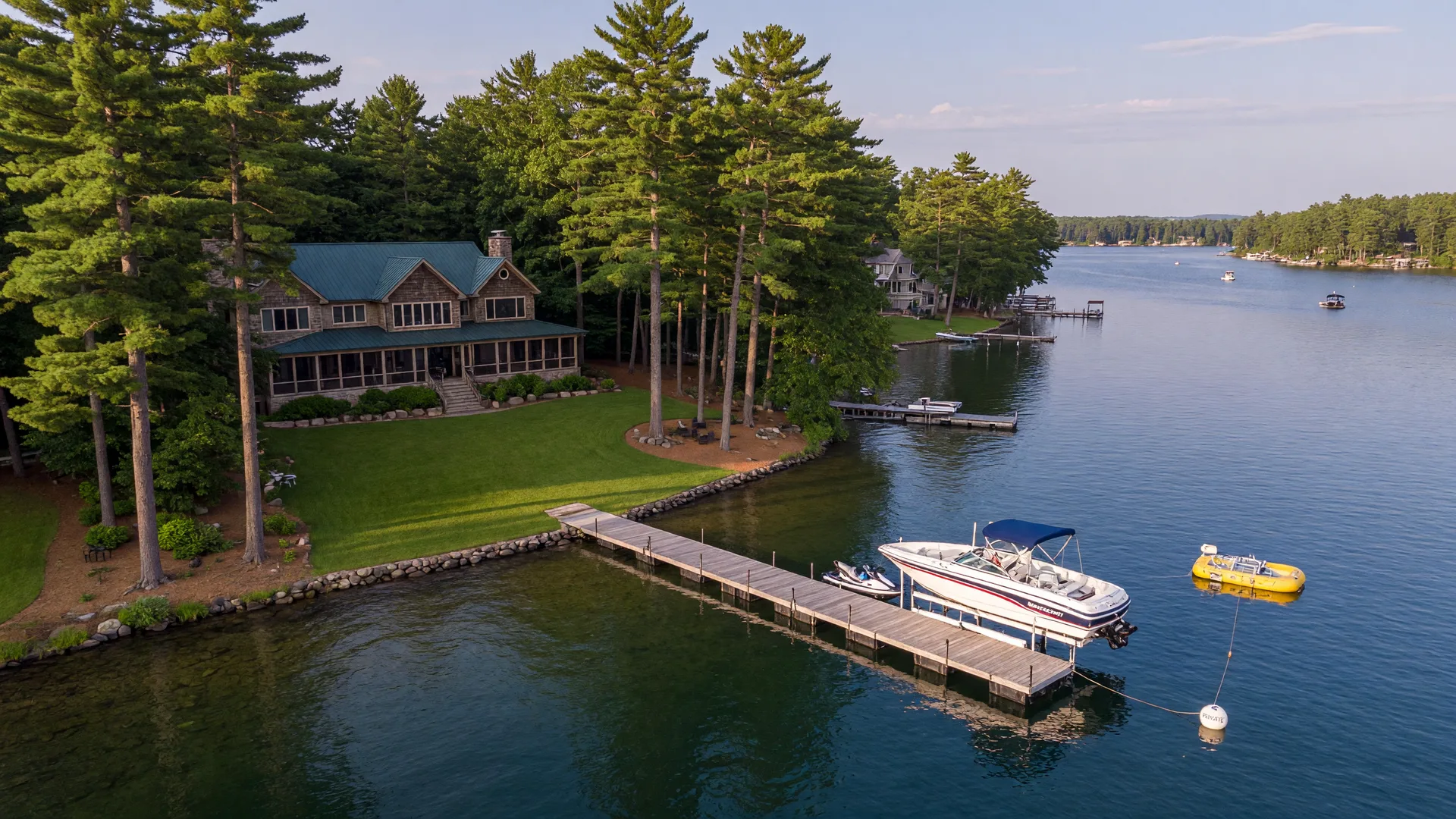 Aerial view of a premium lakefront property with a long wooden dock on a Minnesota lake