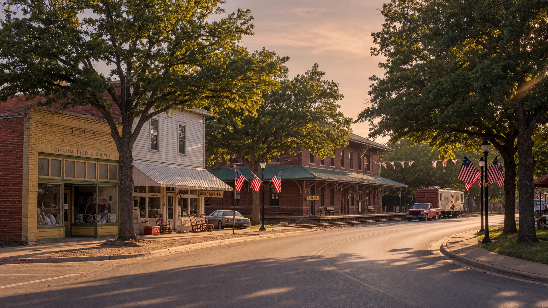 Peaceful small-town Main Street in Omaha, Texas with historic storefronts and golden-hour summer lighting