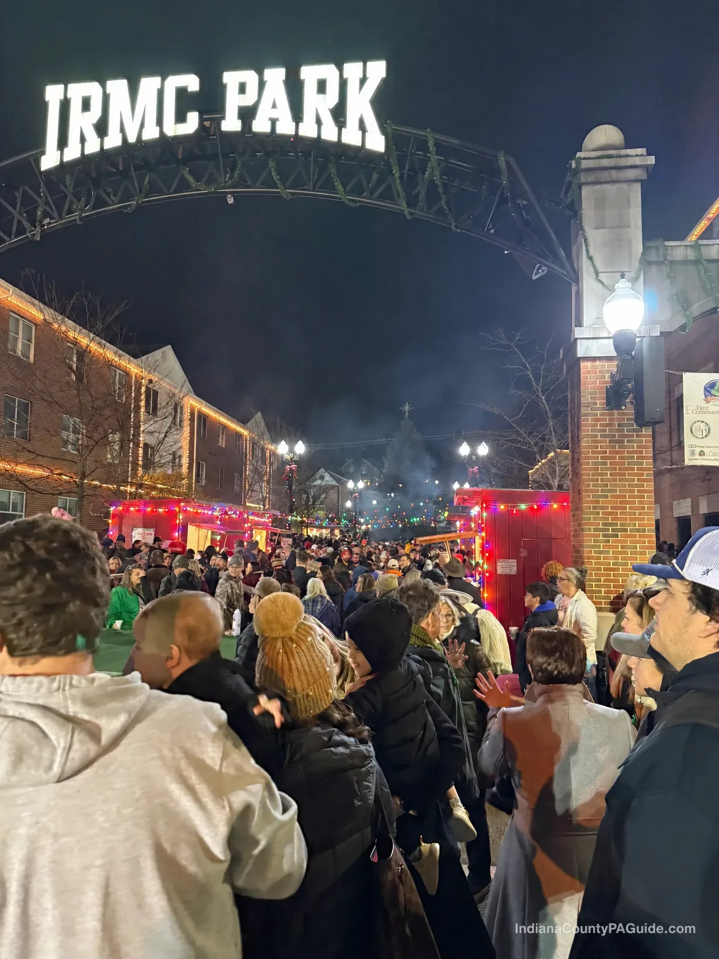 IRMC Park at night with holiday lights and a gathered crowd in Indiana, PA