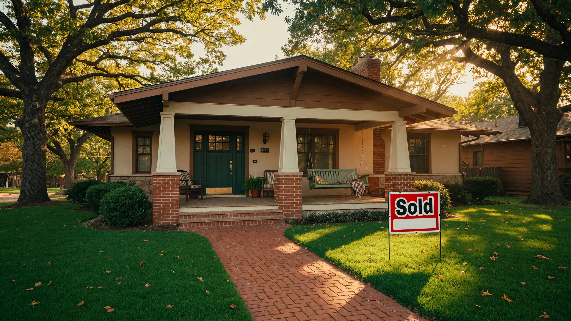 Craftsman-style home in a Tulsa neighborhood with a Sold sign in the front yard on a sunny afternoon